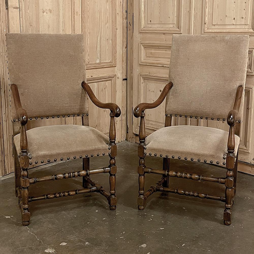 Pair Antique French Louis XIII Armchairs are generously sized to provide abundant comfort while presenting a splendid Old World style into the room.  Recently upholstered in a fine quality, neutral colored chenille fabric, each has high, squared