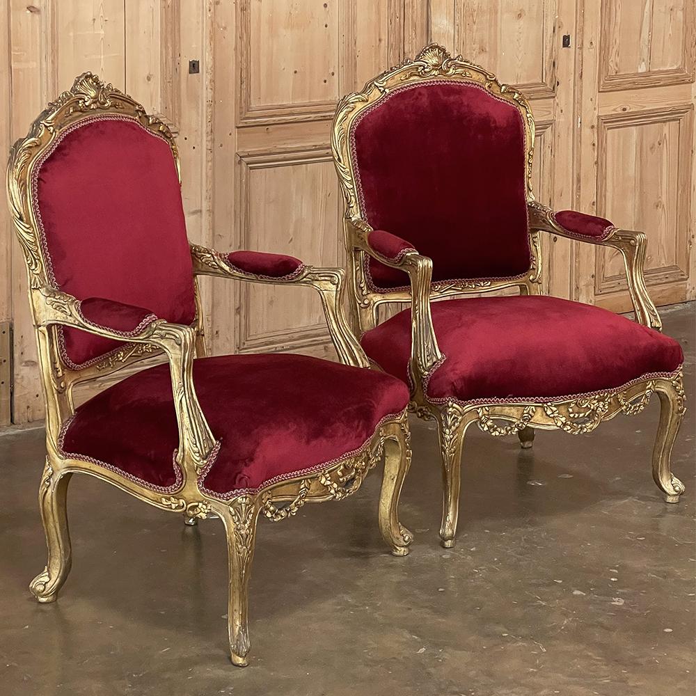 Paire de fauteuils anciens en bois doré Louis XIV ~ Fauteuils ajoutera une grâce et une élégance intemporelle à votre pièce digne des rois de France ! Chaque cadre est méticuleusement sculpté avec d'élégantes formes en volutes, puis orné de motifs