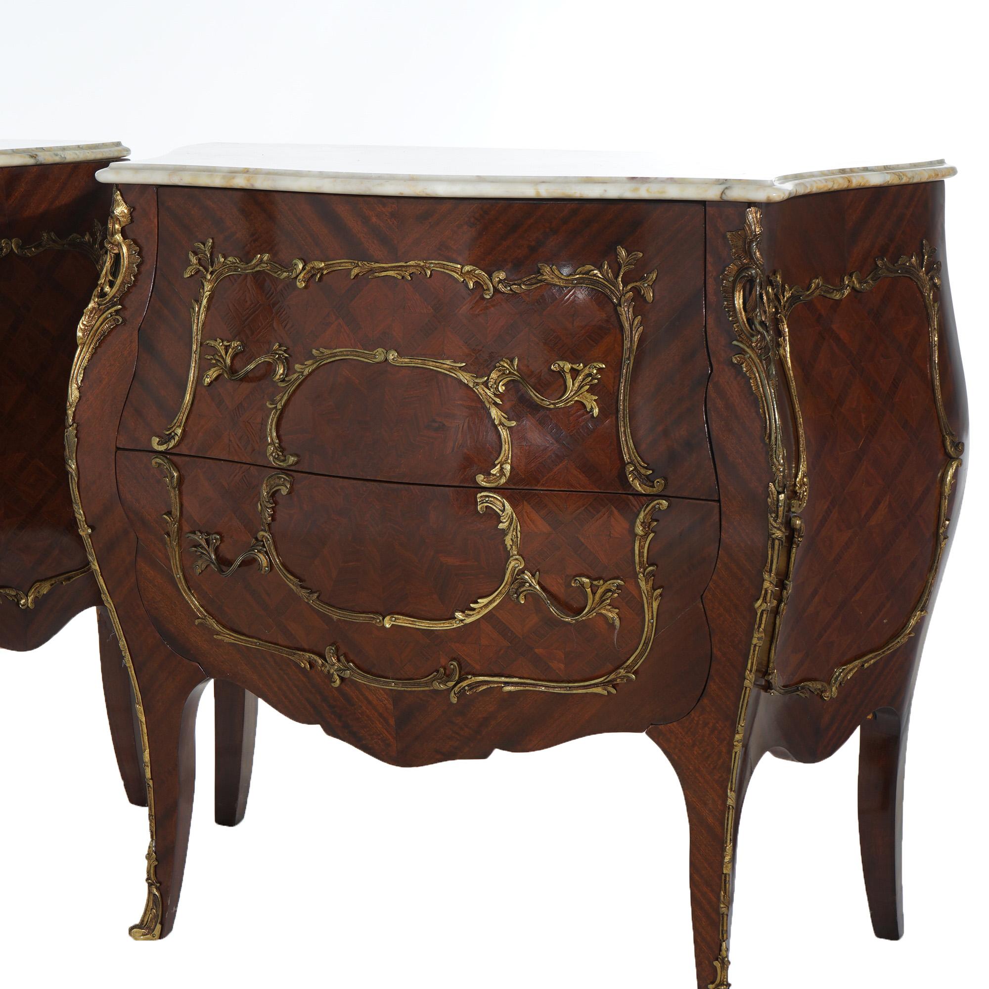 ***Ask About Reduced In-House Shipping Rates - Reliable Service & Fully Insured***

A matching pair of French Louis XIV commodes offer shaped marble tops over bombe form cases with kingwood parquetry, foliate form ormolu, double drawers and raised