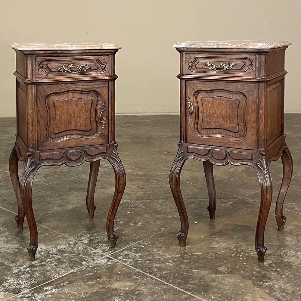 Pair Antique French Louis XV marble top nightstands will make great companions in any room! Hand-crafted from solid oak to last for generations, each has been adorned with carved detail on the four boldly scrolled cabriole legs embellished with