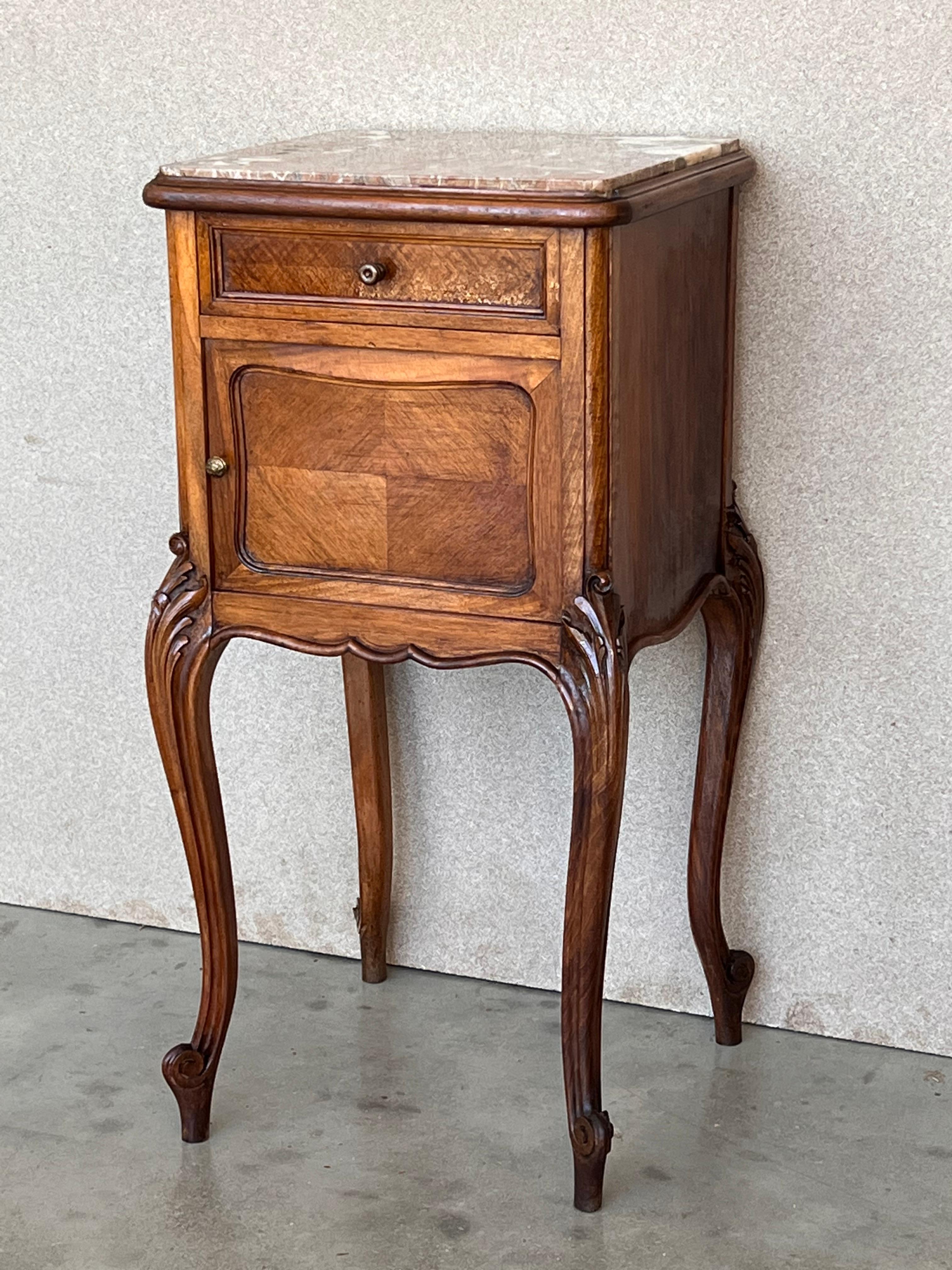 Pair antique French Louis XV marble top nightstands will make great companions in any room! 
Handcrafted from solid oak to last for generations, each has been adorned with carved detail on the four boldly scrolled cabriole legs embellished with