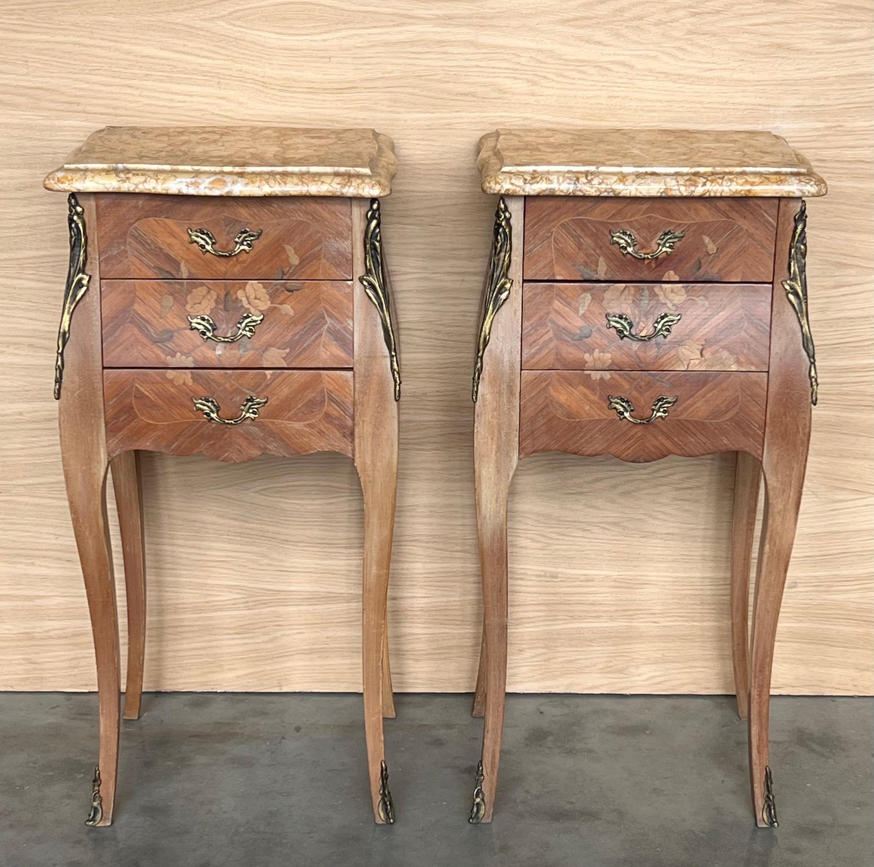 Pair Antique French Louis XV Marquetry marble top nightstands offer a lot of style in diminutive packages! The subtle contours and scroll forms are evident in the cornerposts and legs, supporting serpentine sides and a bowed front facade for a