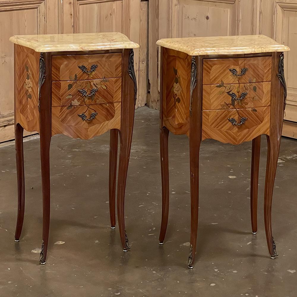 Pair Antique French Louis XV Marquetry marble top nightstands offer a lot of style in diminutive packages! The subtle contours and scroll forms are evident in the cornerposts and legs, supporting serpentine sides and a bowed front facade for a