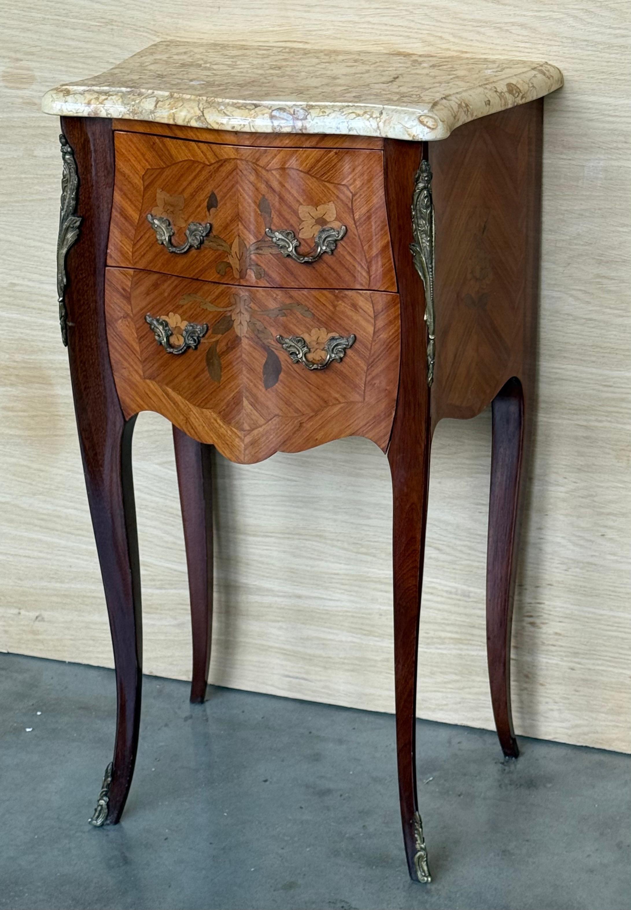 Pair Antique French Louis XV Marquetry marble top nightstands offer a lot of style in diminutive packages! The subtle contours and scroll forms are evident in the cornerposts and legs, supporting serpentine sides and a bowed front facade for a