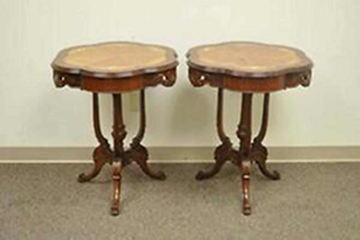 Beautiful pair of antique pedestal base French end tables. Item features beautiful floral inlays, satinwood sunburst tops, carved solidwood bases and elegant French form.