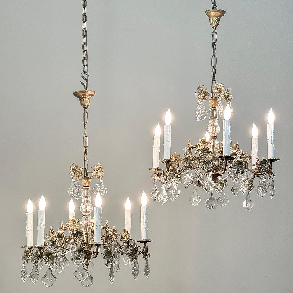 Pair Antique French Louis XVI Bronze & Crystal Chandeliers are truly a rare and special find!  Meticulously hand-crafted from cast bronze and fitted with a wide variety of naturalistic cut crystal designs, each sports its original canopy and a short