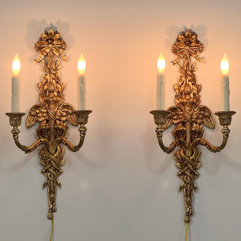 Pair Antique French Louis XVI Bronze Wall Sconces are an exquisite example of the metalsmith's art!  Cast in solid bronze, each has achieved a lovely patina over the decades.  The detail is astounding, with ribbons, foliates, tassels, and most
