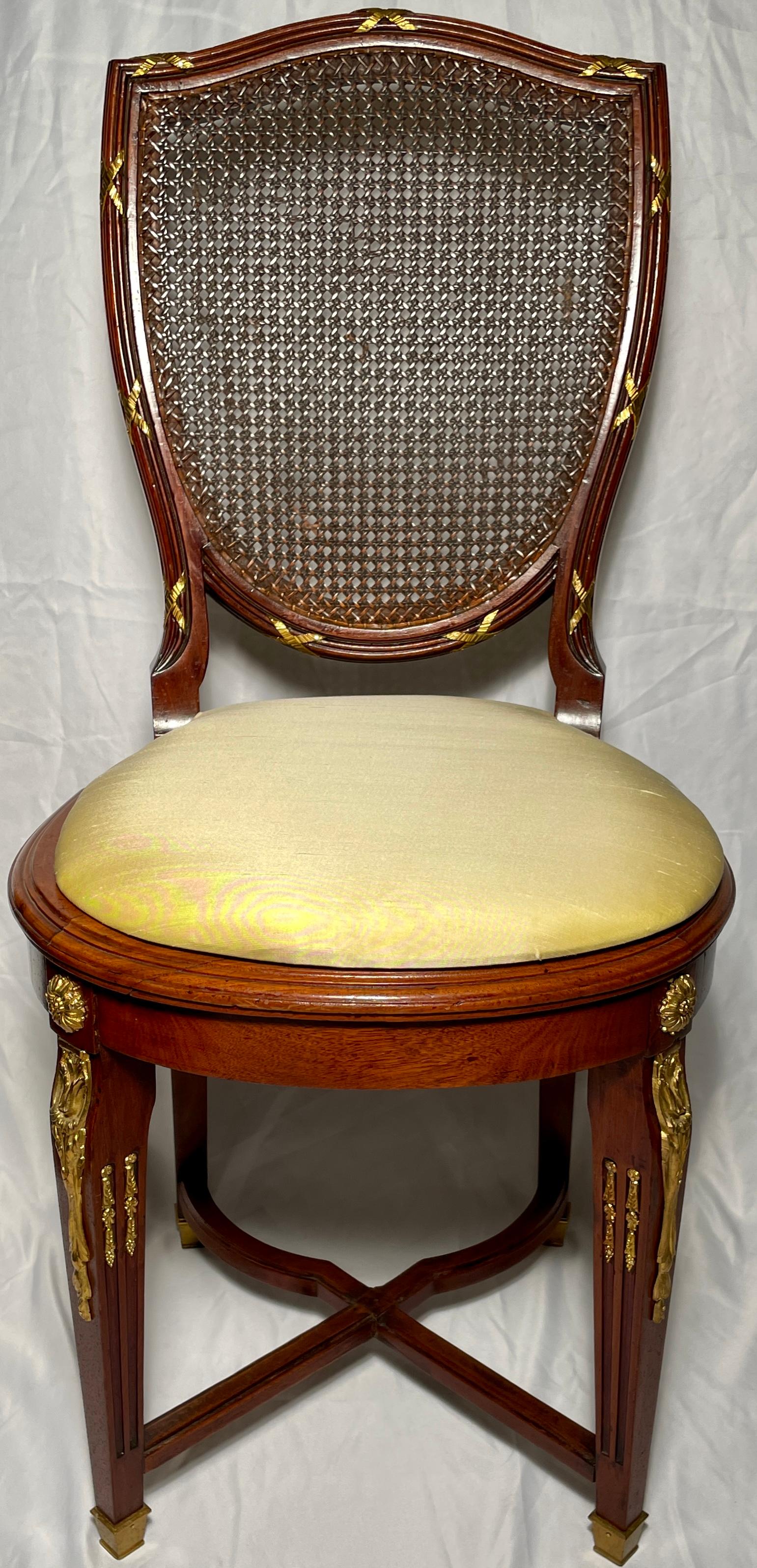 Pair antique French Louis XVI gold bronze mounted mahogany cane back chairs.