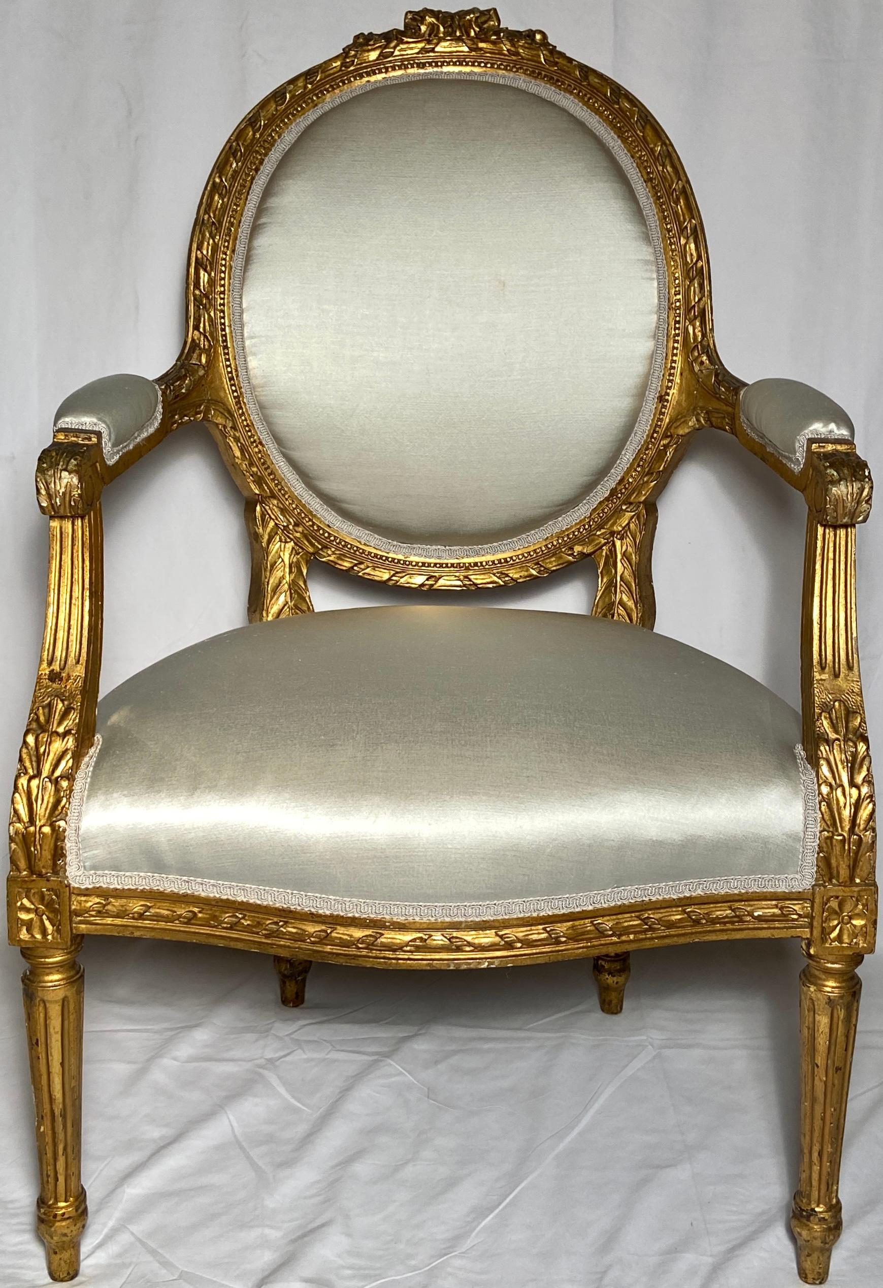 Pair Antique French Louis XVI gold leaf armchairs, circa 1890.