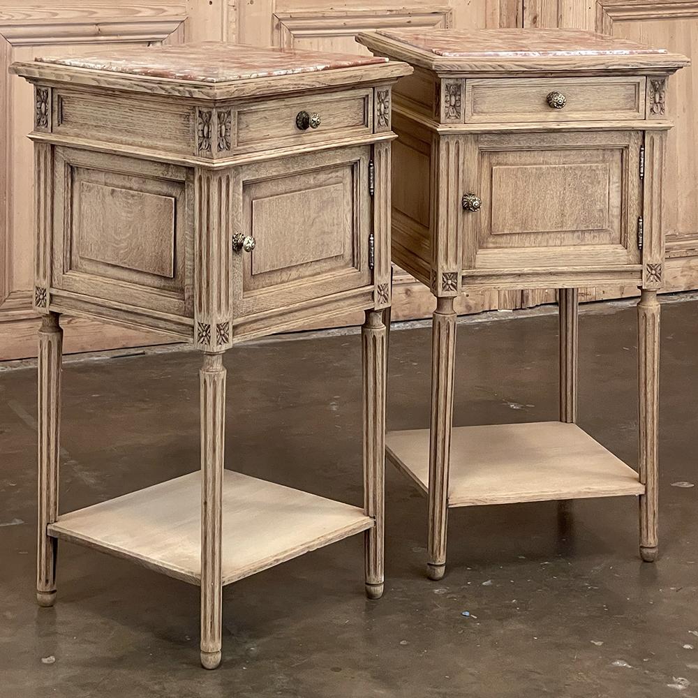 Pair Antique French Louis XVI Marble Top Nightstands in Stripped Oak are perfect examples of the tailored neoclassical look, with style inspiration that dates back to ancient Greece and Rome, but executed in a restrained manner making the pair ideal