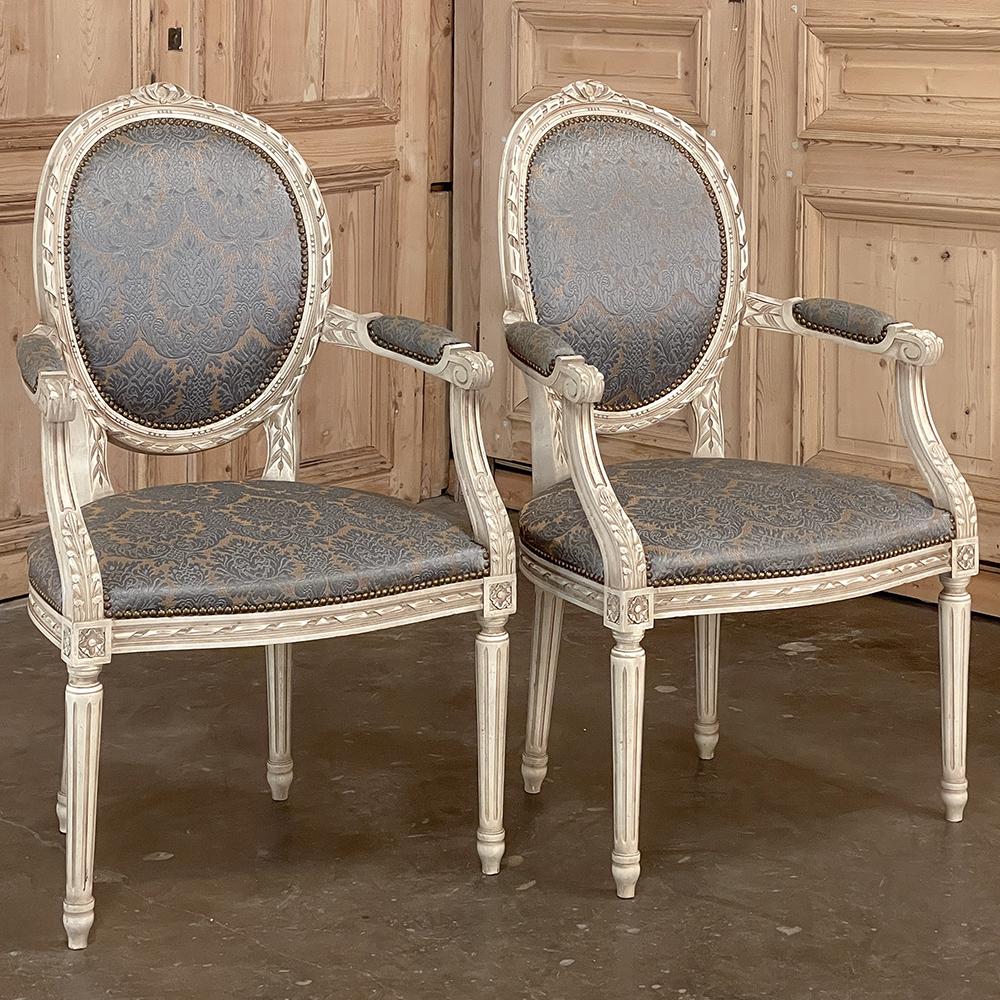 Pair Antique French Louis XVI painted armchairs ~ Fauteuils represent the classical interpretation of the design! Oval, contoured seatbacks and generously proportioned seats provide unusual comfort, with the frames enveloping the luxurious damascene