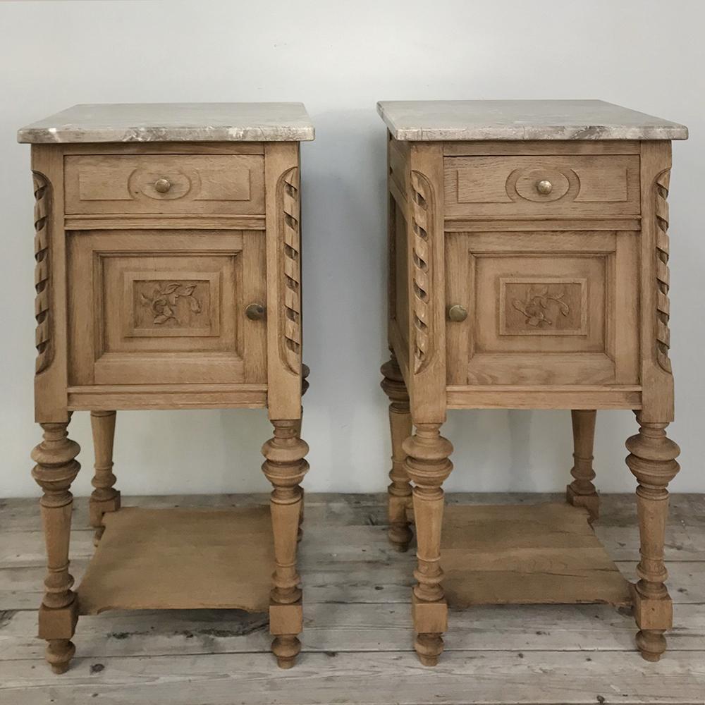 Pair of antique French Louis XVI stripped marble top nightstands feature tailored neoclassical lines, cabinet and drawer each and luxurious carefree marble tops with a splendid neutral color and subtle veining. Lower shelf adds a convenient surface,