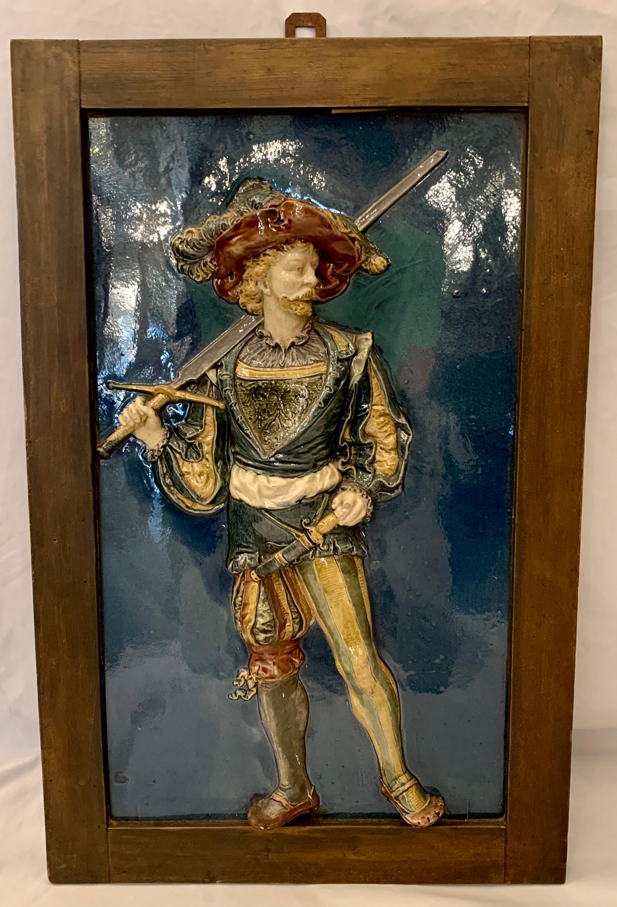 Rare large pair antique French Majolica porcelain tile high relief wall plaques of Louis XIV musketeers, Circa 1900-1910.