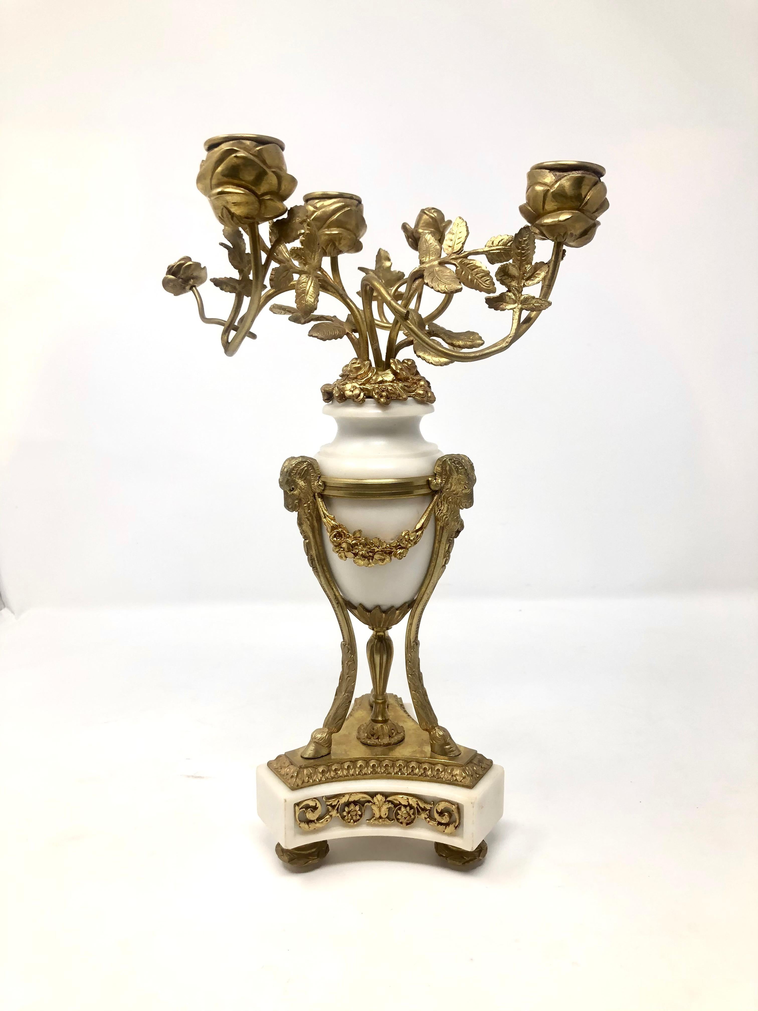 Pair of antique French marble and gold bronze candelabra with ram's heads, floral and wreath details, Circa 1860-1870.