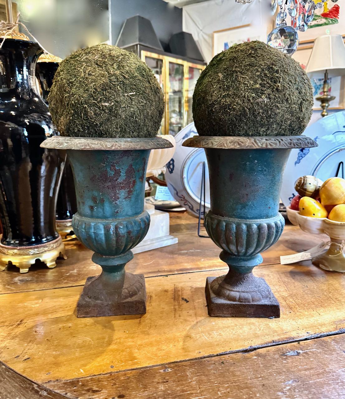 This is a wonderful pair of late 19th century French cast iron urns that have retained their original French Robin's Egg blue surface. The original surface has acquired a deep natural patina during its many years of life. The patinated blue of these