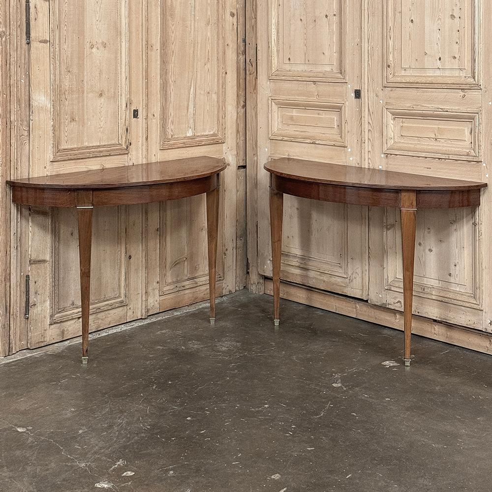Pair Antique French Neoclassical Fruitwood Demilune Consoles were elegantly designed in polished fruitwood to create a tailored yet luxurious look, and to provide symmetry for any room!  The demilune form means no sharp corners anywhere in the