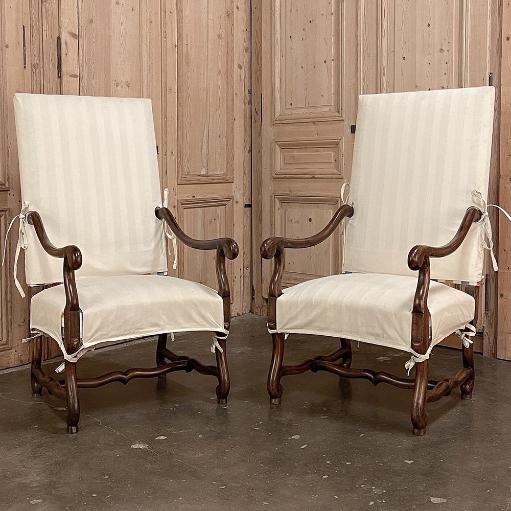 Pair antique French Os de Mouton armchairs with slip covers will make a great addition to your decor! The upholstery has been kept in pristine condition thanks to the full coverage tie-on slip covers, which are included in this purchase. The