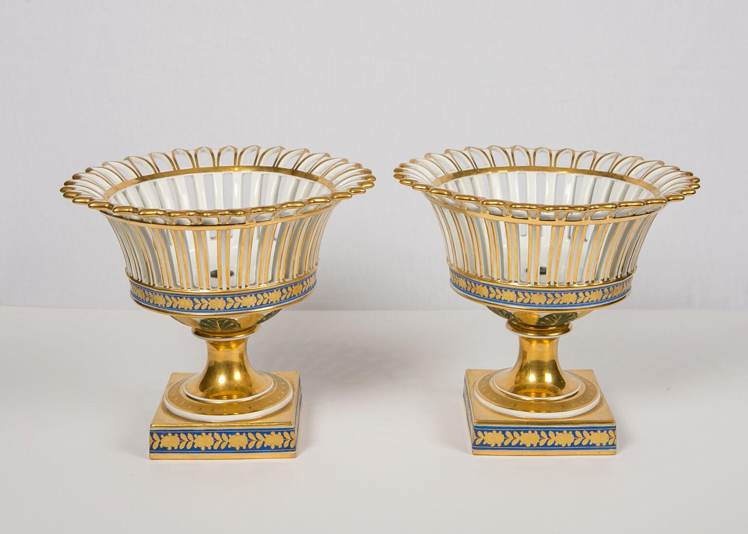 We are pleased to offer this elegant pair of Paris Porcelain gilded baskets. The decoration is lovely. The baskets are pierced and arcaded with everted rims. The gilding is lavish. The blue band along the bottom of each basket is decorated with