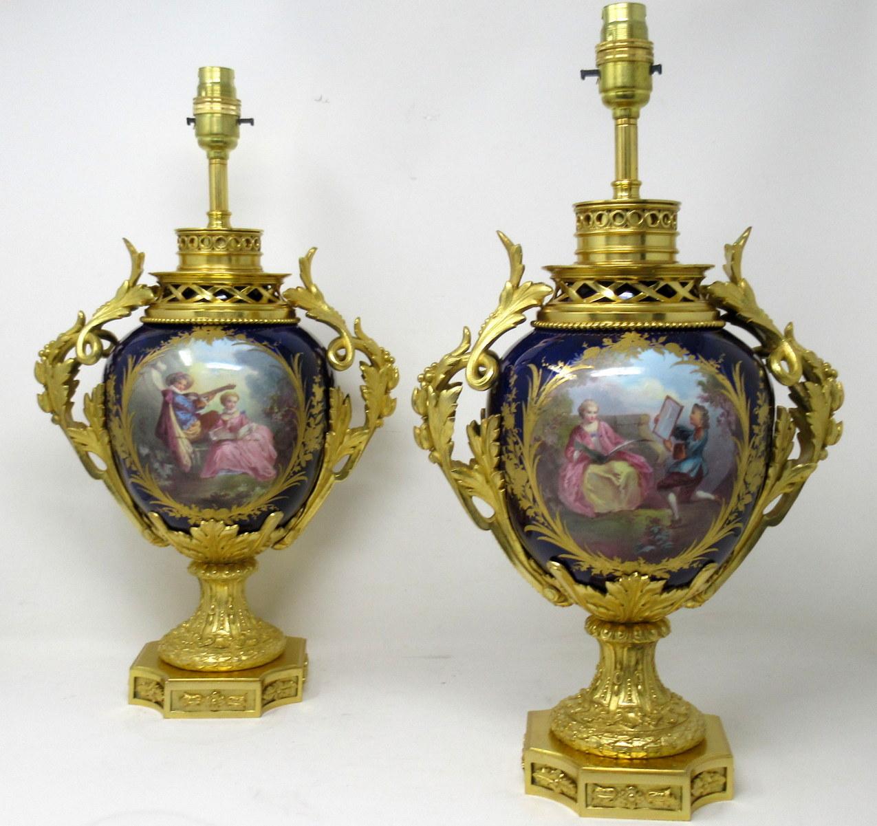 Stunning imposing Pair of French Sevres Soft Paste Porcelain and Ormolu Twin Handle Electric Table Lamps of traditional bulbous form, and of good size proportions, raised on a very ornate dome shaped circular base on a plain square support with