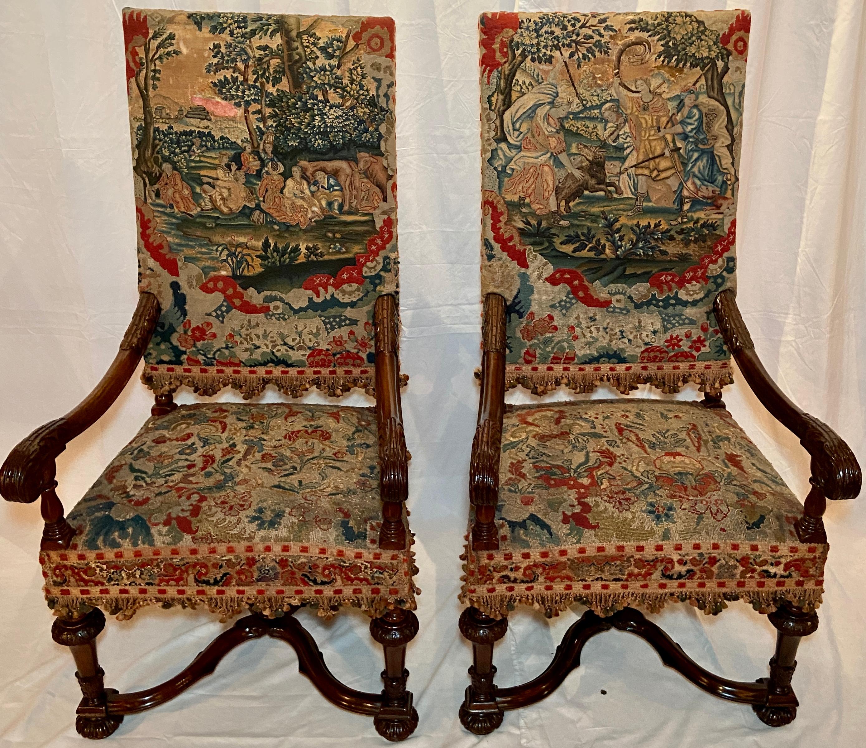 Pair Antique French tapestry armchairs, circa 1890's. 
Substantial in size and beautifully carved--these chairs are upholstered with fine old tapestry. Per photo 11/15 some minor wear is present on the tapestry due to the age of the pieces.