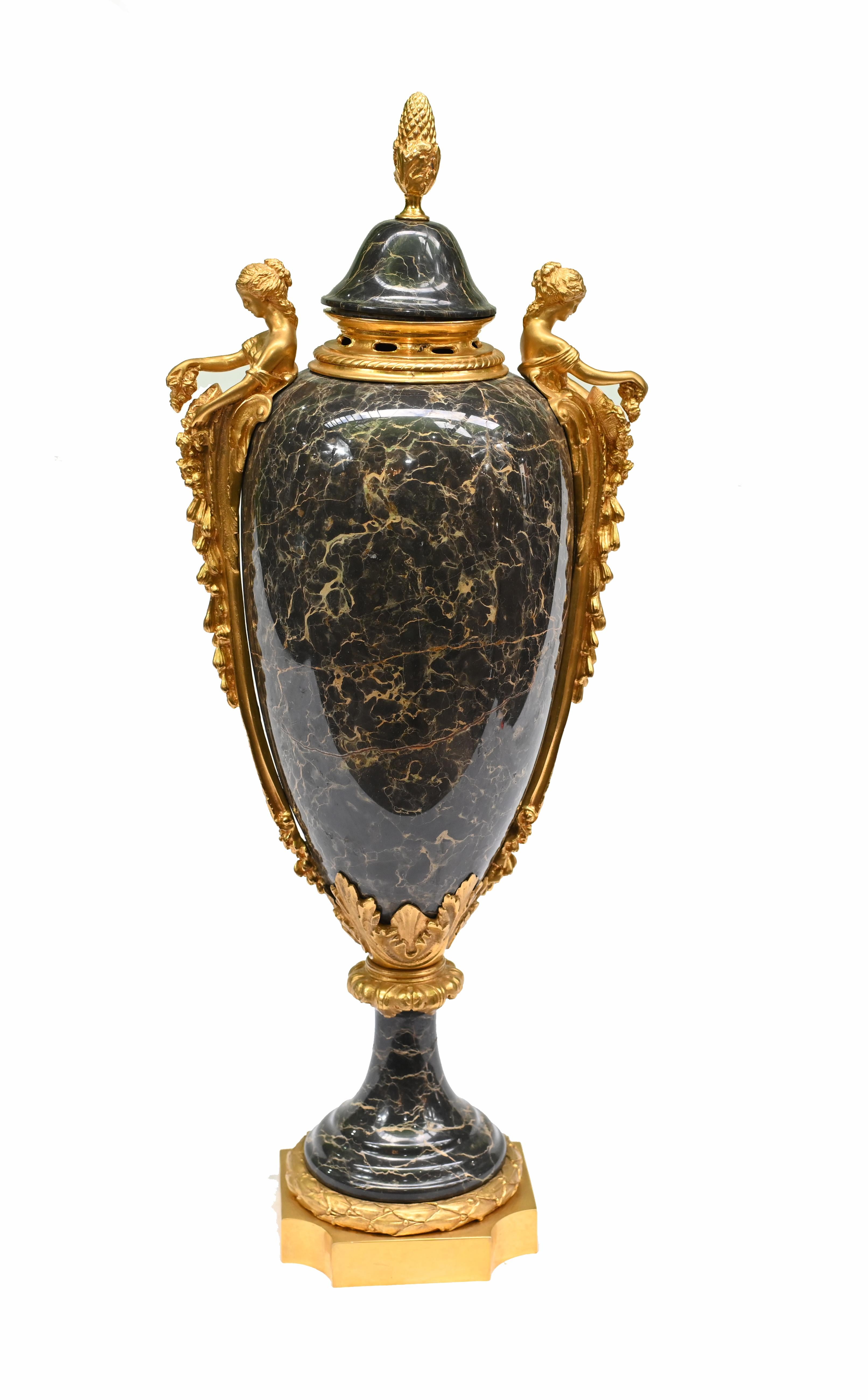 Delightful pair of French marble cassolettes urns
Solid marble with ormolu fixtures including distinctive maiden handles
We date these to circa 1890 and the urns are of a classical amphora form
The stone is black Portoro marble with such a beautiful