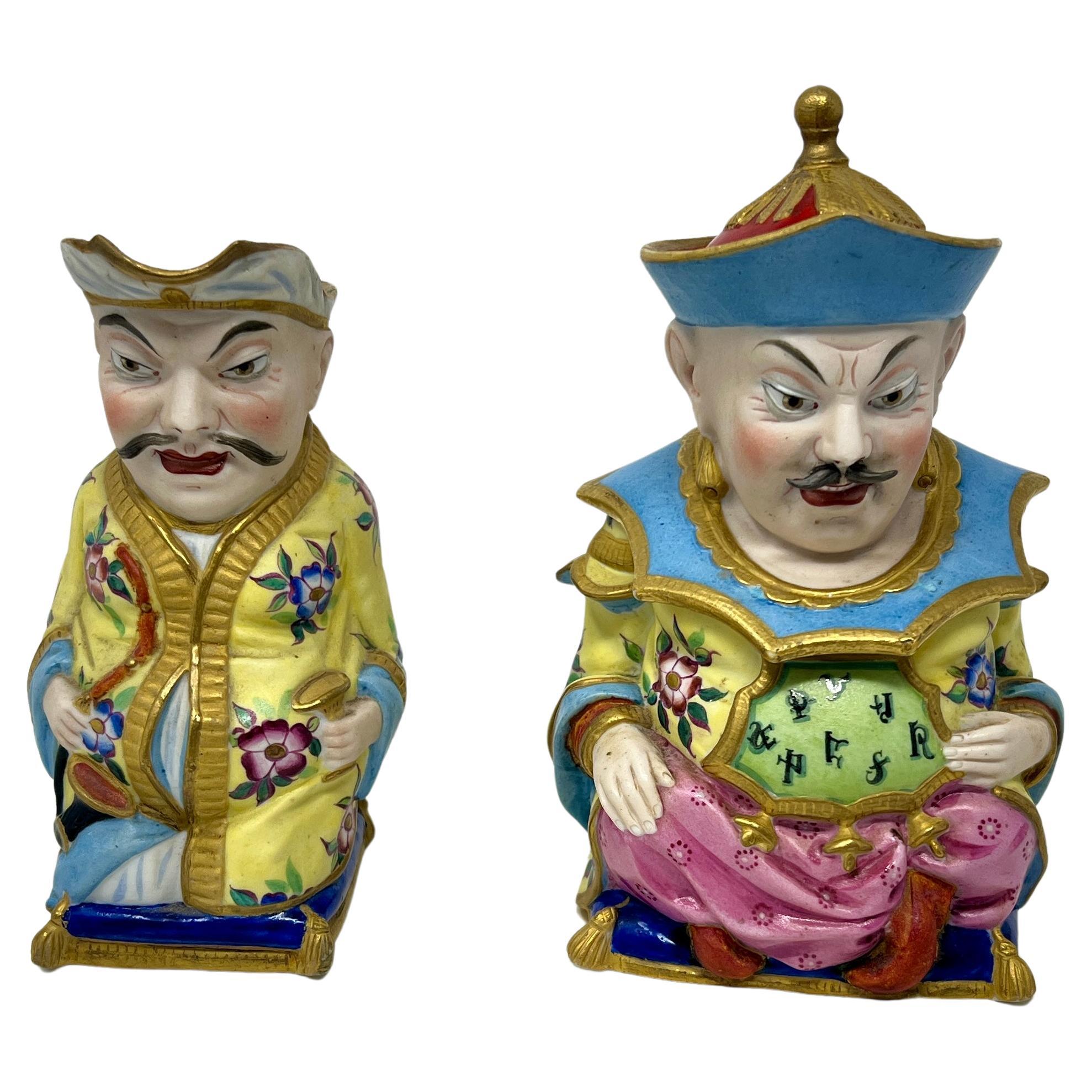 Paire de figurines anciennes en porcelaine du Vieux Paris peintes à la main : Crémier et Sucre, Circa 1880.
Sucre
	H = 6.5
	W = 4.5 
	D = 3.5
Crème
	H = 5.5
	W = 4.25
	D = 3.25

