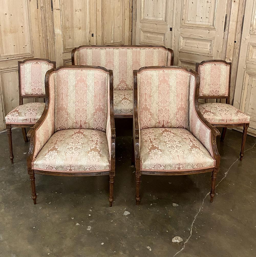Pair of antique French walnut Louis XVI side chairs are part of an exquisite salon set which includes the pair of bergère (armchairs) and canapé (sofa) that are available as of this writing. This pair of chairs, sold separately, features banded