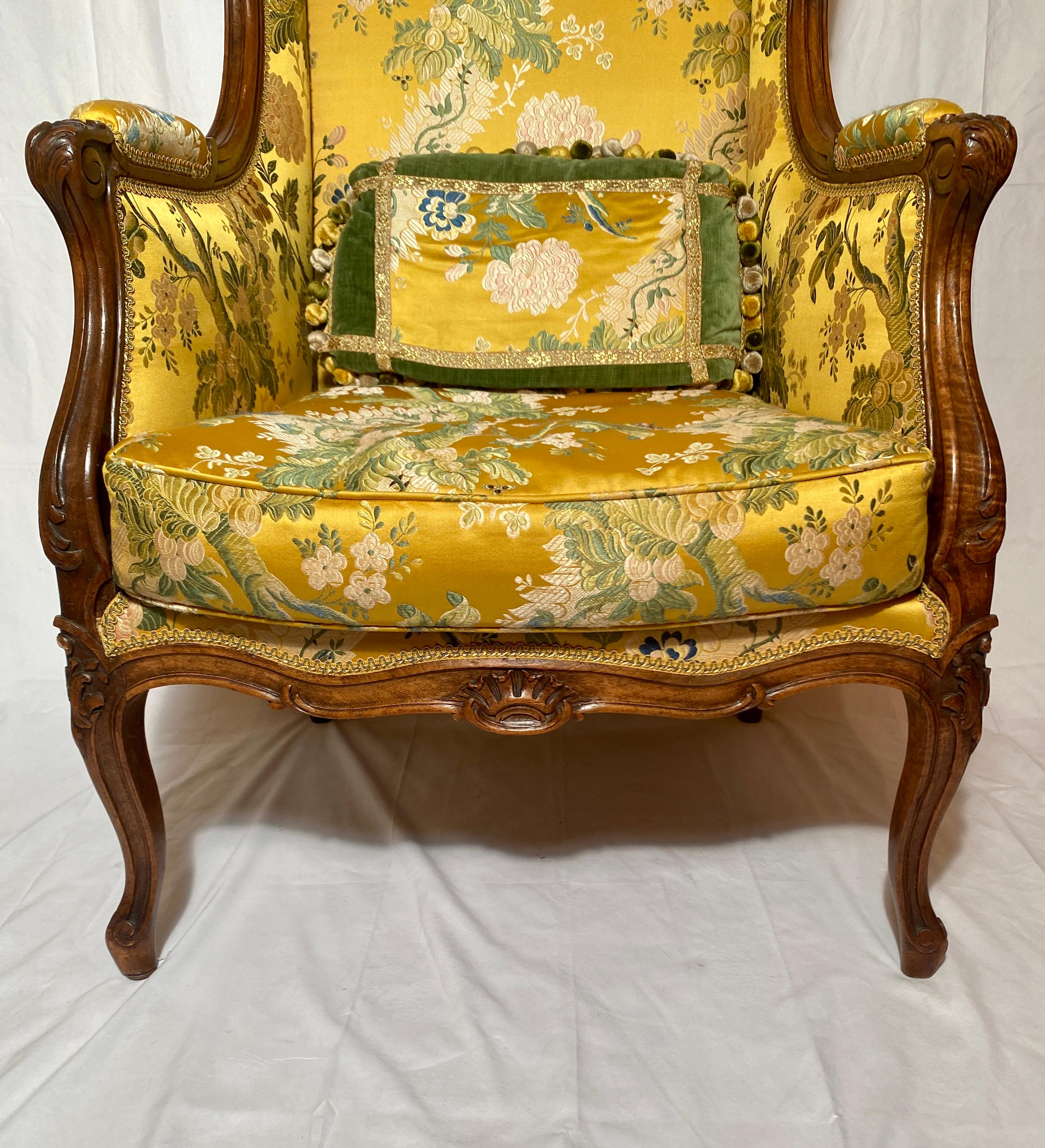 Pair antique French walnut wing chairs with fine yellow and green upholstery, circa 1860.