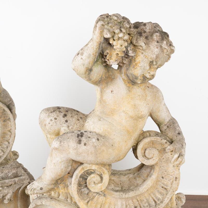 Stone Pair, Antique Garden Cherub Putti Statues with Flowers and Grapes For Sale