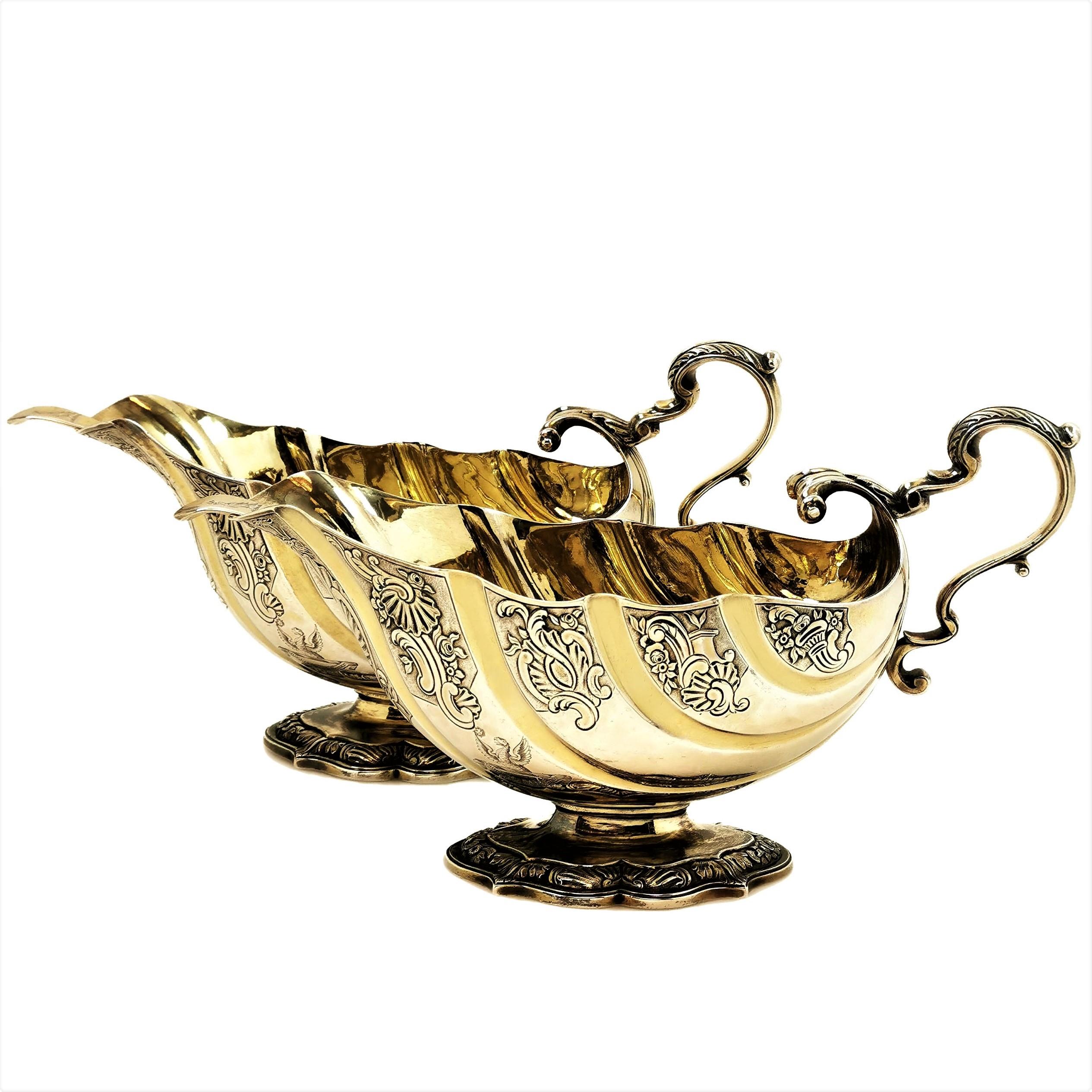 A magnificent pair of Antique George III sterling Silver Sauce Boats in an impressive Rocco Revival Style, referencing the Rococo designs of the 1740s. The Gravy Boats have a beautiful stylised shell shape and are decorated with chased designs.