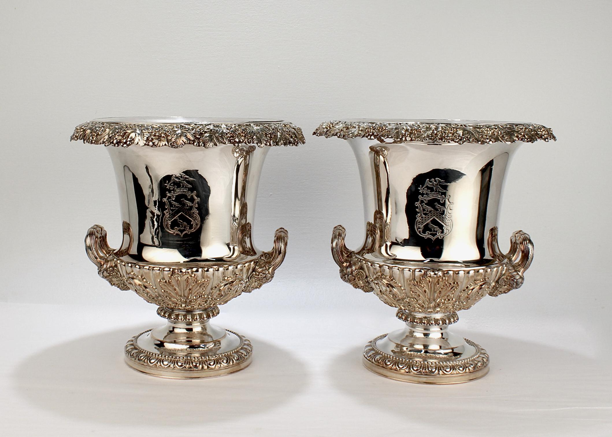 A very fine pair of crested Georgian Sheffield Plate campagna-form wine coolers.

Made by T. & J. Creswick of Birmingham, England.

Each has an engraved armorial crest, reeded handles that terminate in figural masks, and a grape and grape leaf