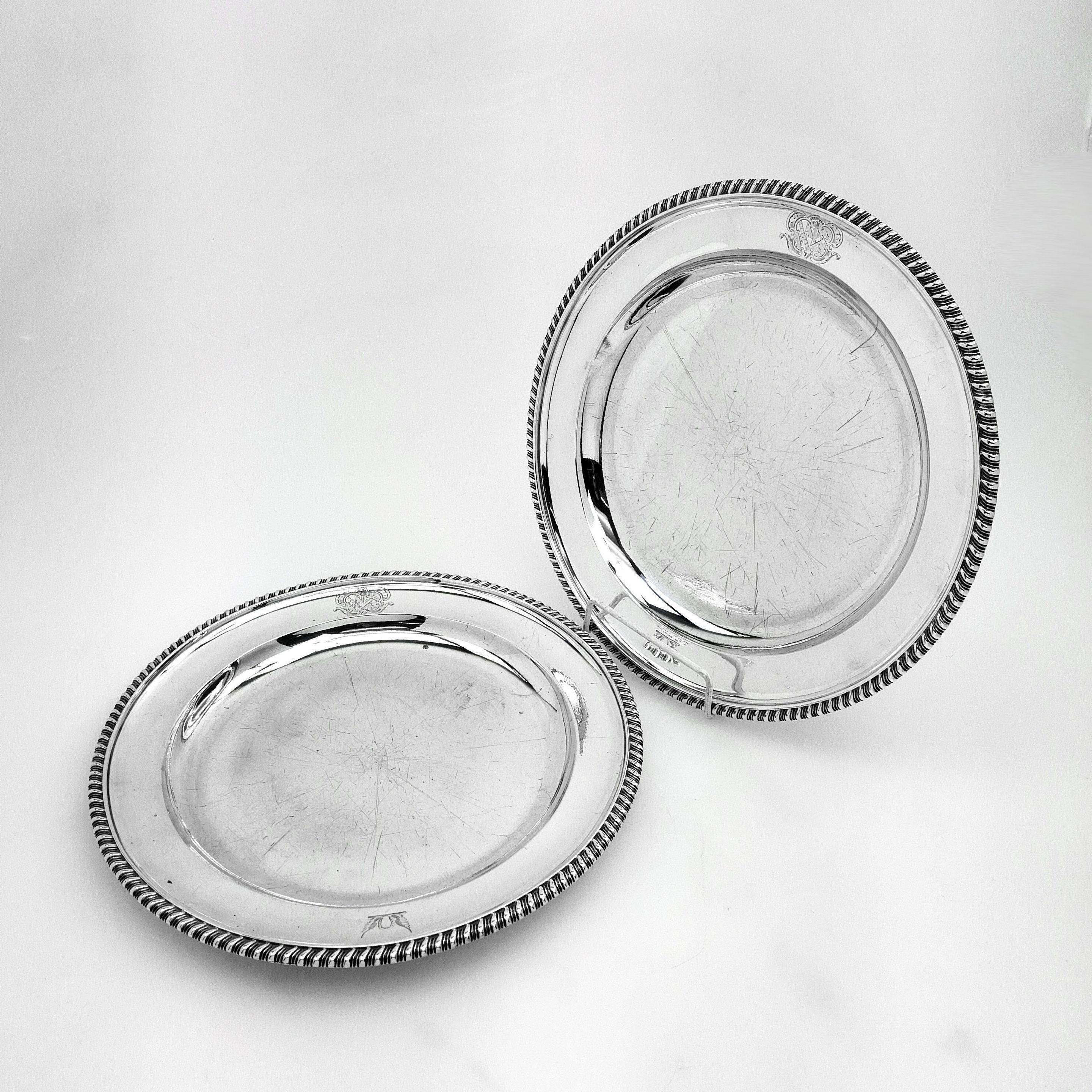 A pair of classic Antique Georgian solid Silver Second Course Dishes / Plates with a classic gadroon border. Each Dish has a pair of crests engraved one on each side of the rim on each plate.
 
 Made in London in 1823 by William Eley.
 
 Approx.