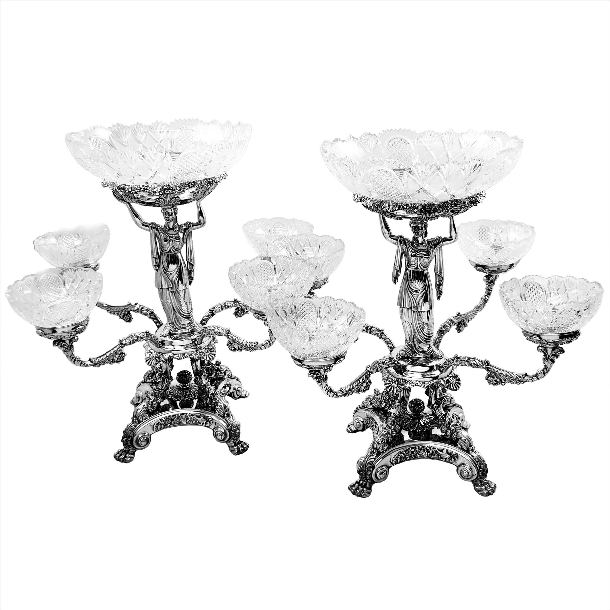 A pair of magnificent antique George IV Epergnes with elegant sterling silver classical figures supporting the central cut glass bowl. The rest of the impressive centrepiece is made in traditional Old Sheffield plate and four branches support four