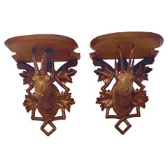 Paire de supports muraux anciens en bois sculpté de la Forêt Noire allemande, vers les années 1920.