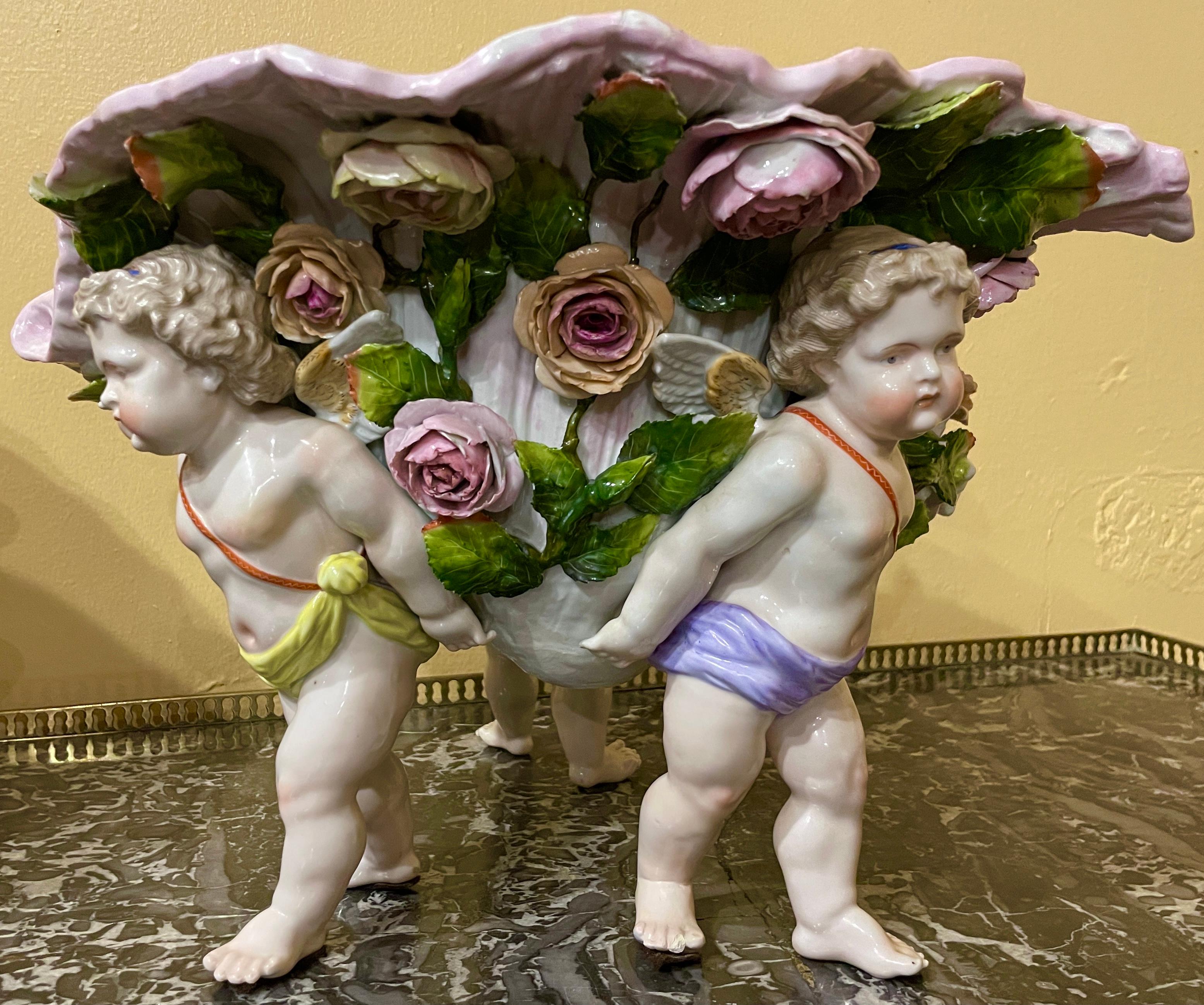 Pair antique German Dresden porcelain hand-painted shell centerpieces, Circa 1890's.
Conch shell motif with winged cherubs and flowers.