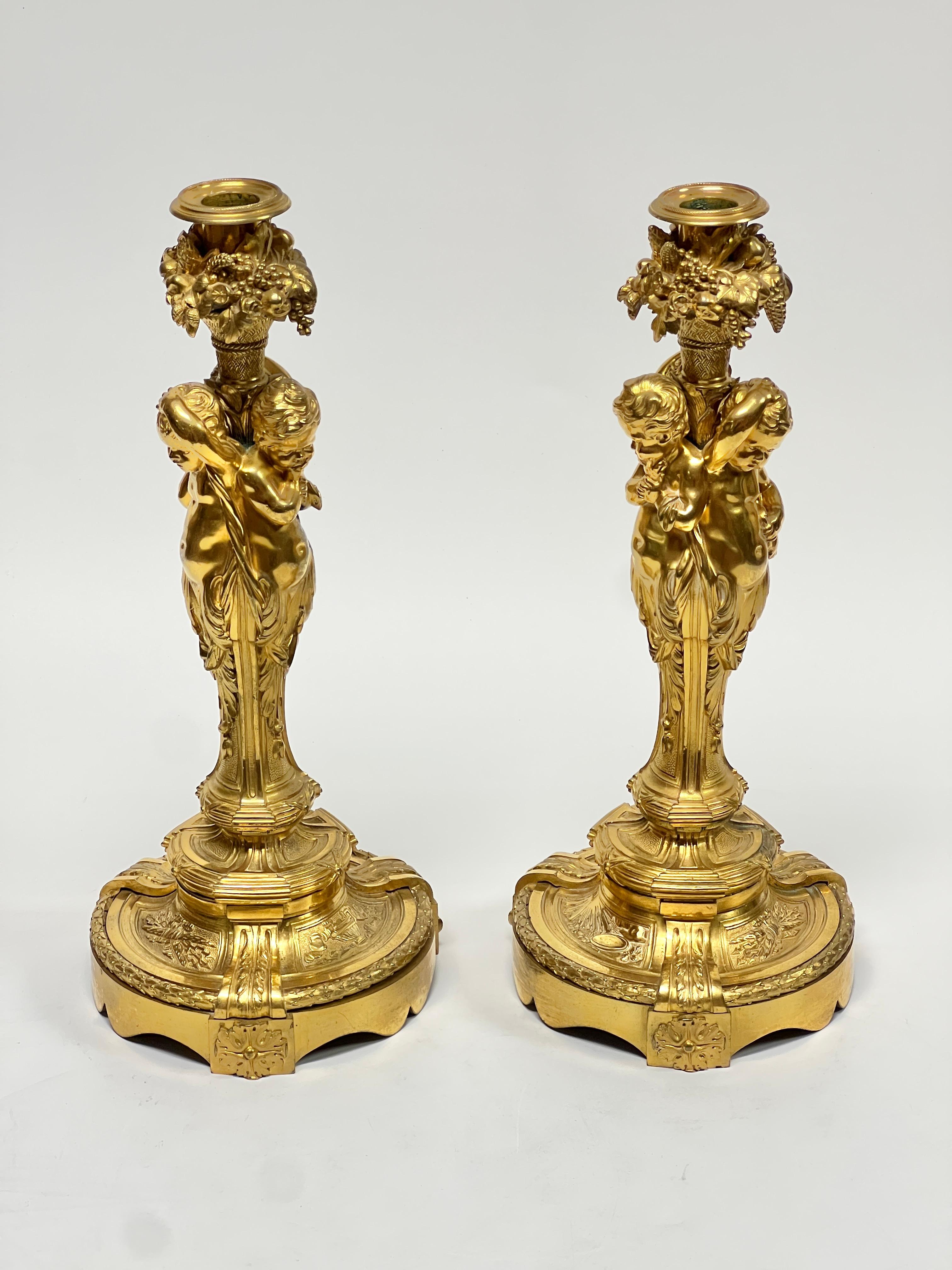Pair of exceptionally cast antique (19th century) ormolu gilt bronze candlesticks in the manner of the Louis XV period models by Juste-Aurele Meissonnier (1695-1750), measuring 15 1/4 by 6 1/2 by 6 1/2 inches.  Apparently unsigned.