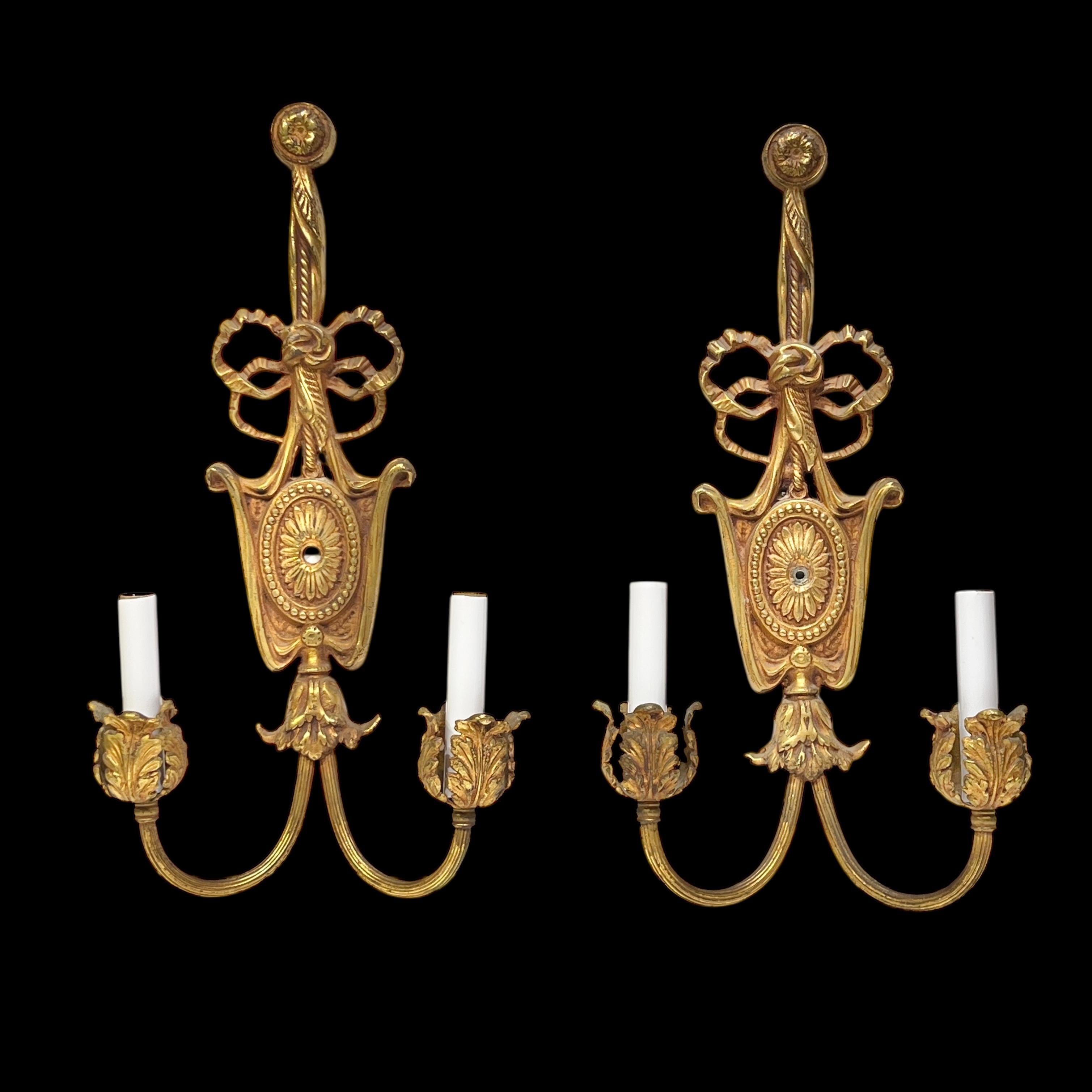 Pair of antique (late 19th century) gilt bronze wall lights (sconces) in the neoclassical style measuring 18 1/2 inches tall, with candelabra size sockets and new candle covers and wiring, ready to install and enjoy.