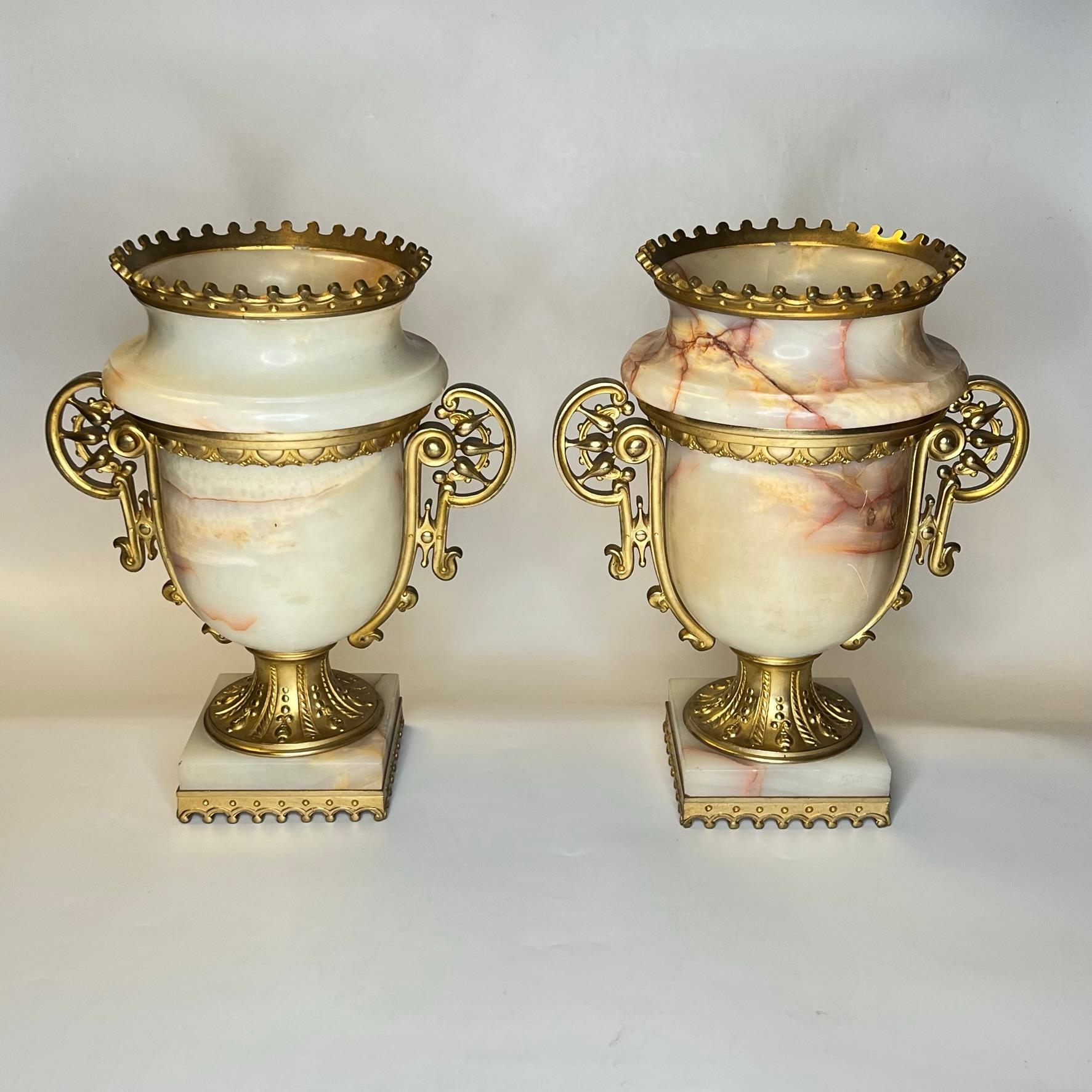 Pair of 19th century continental gilt bronze mounted onyx stone vases in the renaissance style.   Each in good condition, with some hairline cracks to the onyx and rubbing wear to the gilt surfaces.