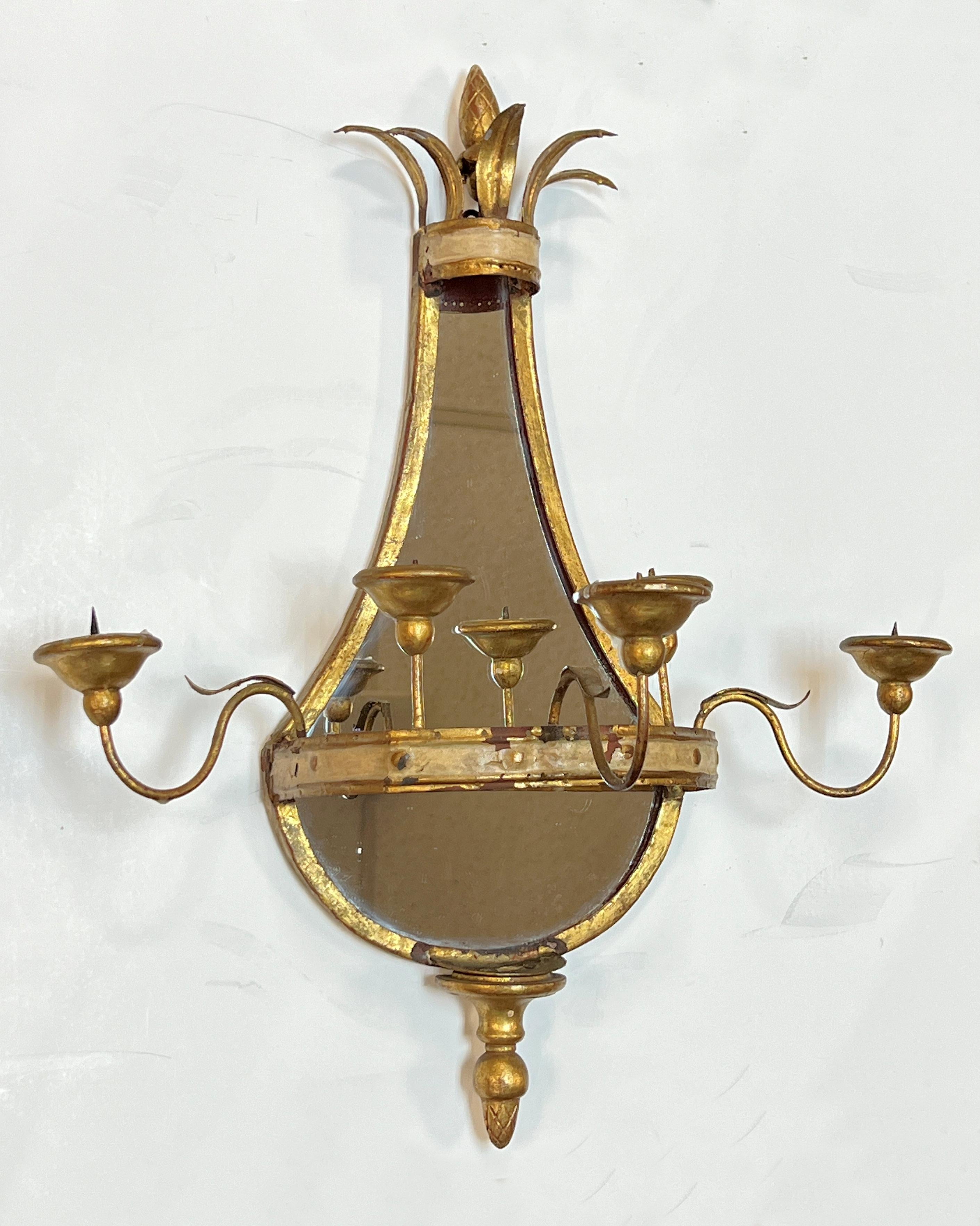 Pair of antique (late 19th century) girandole wall lights (sconces) from the Belle Epoque period, crafted from wood, gilt metal and gesso, with mirrored back plates and hoop shape with four candle arms.  Lacking electric sockets.