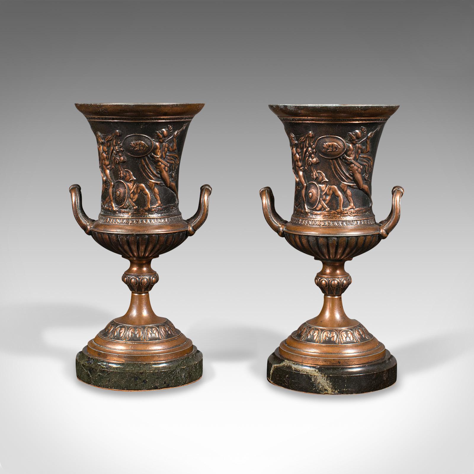 This is a pair of antique Grand Tour urns. An Italian, bronzed decorative vase with Ancient Roman taste, dating to the Victorian period, circa 1850.

Striking urns with evocative historical taste from the Grand Tour era
Displaying a desirable