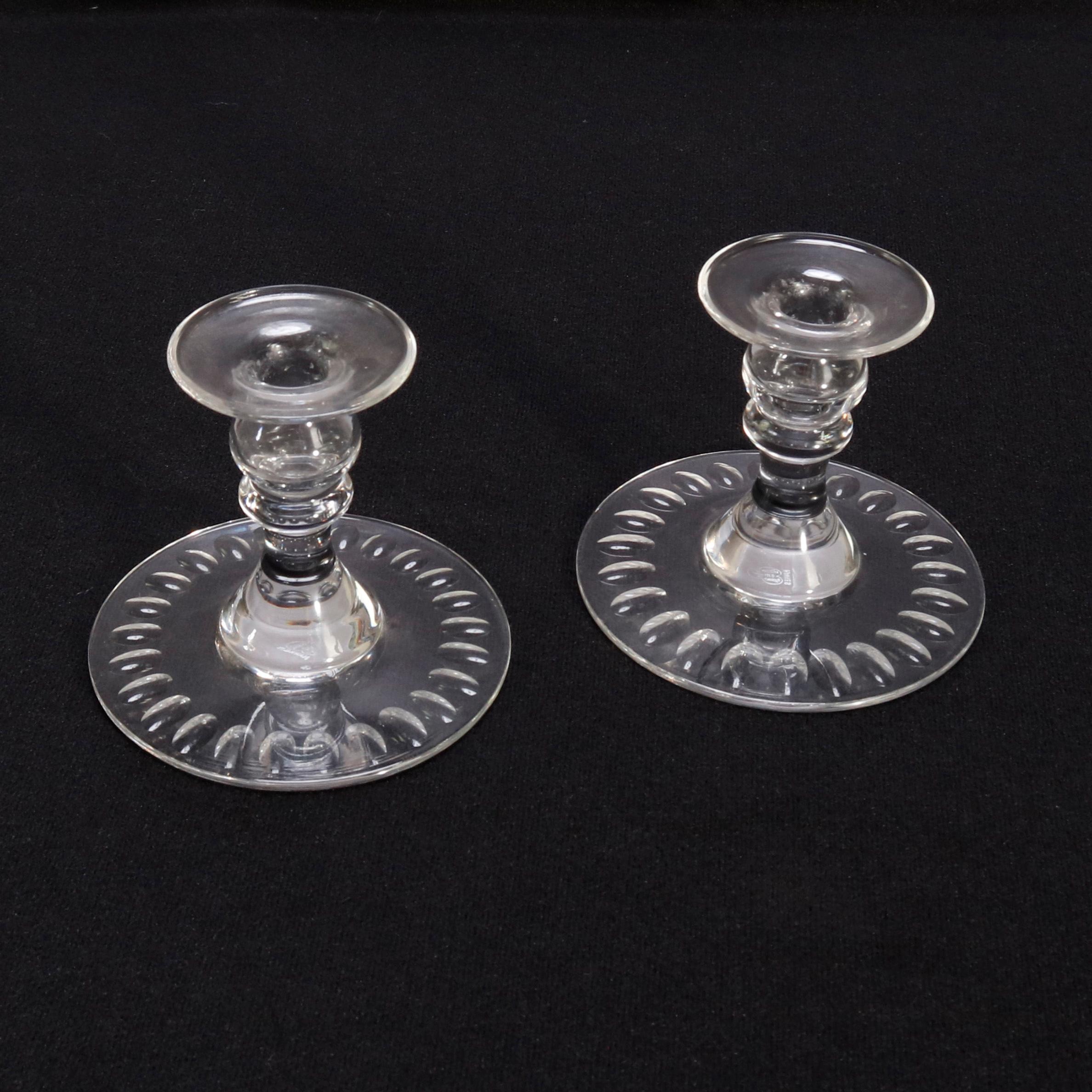 A pair of cut crystal candlesticks by Hawkes offers column form with base having repeating thumb print design, signed on base, 20th century

Measures: 4.25