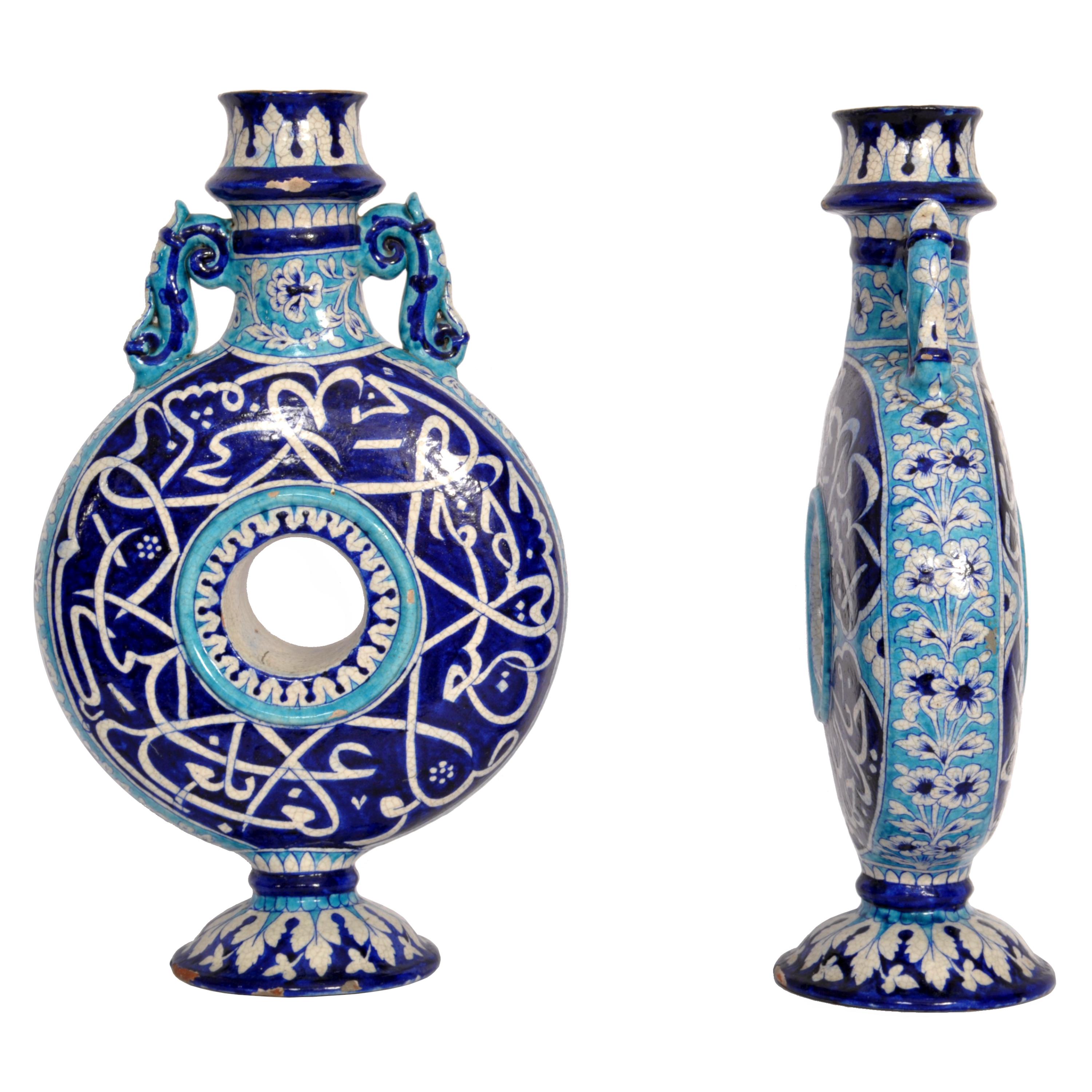 A rare pair of large 19th Century antique Islamic Multan pottery moon flasks, India, Sindh province (now Western Pakistan), circa 1850.
The flasks are decorated in blue, white and turquoise glazes, the top decorated with lappets above an elegant