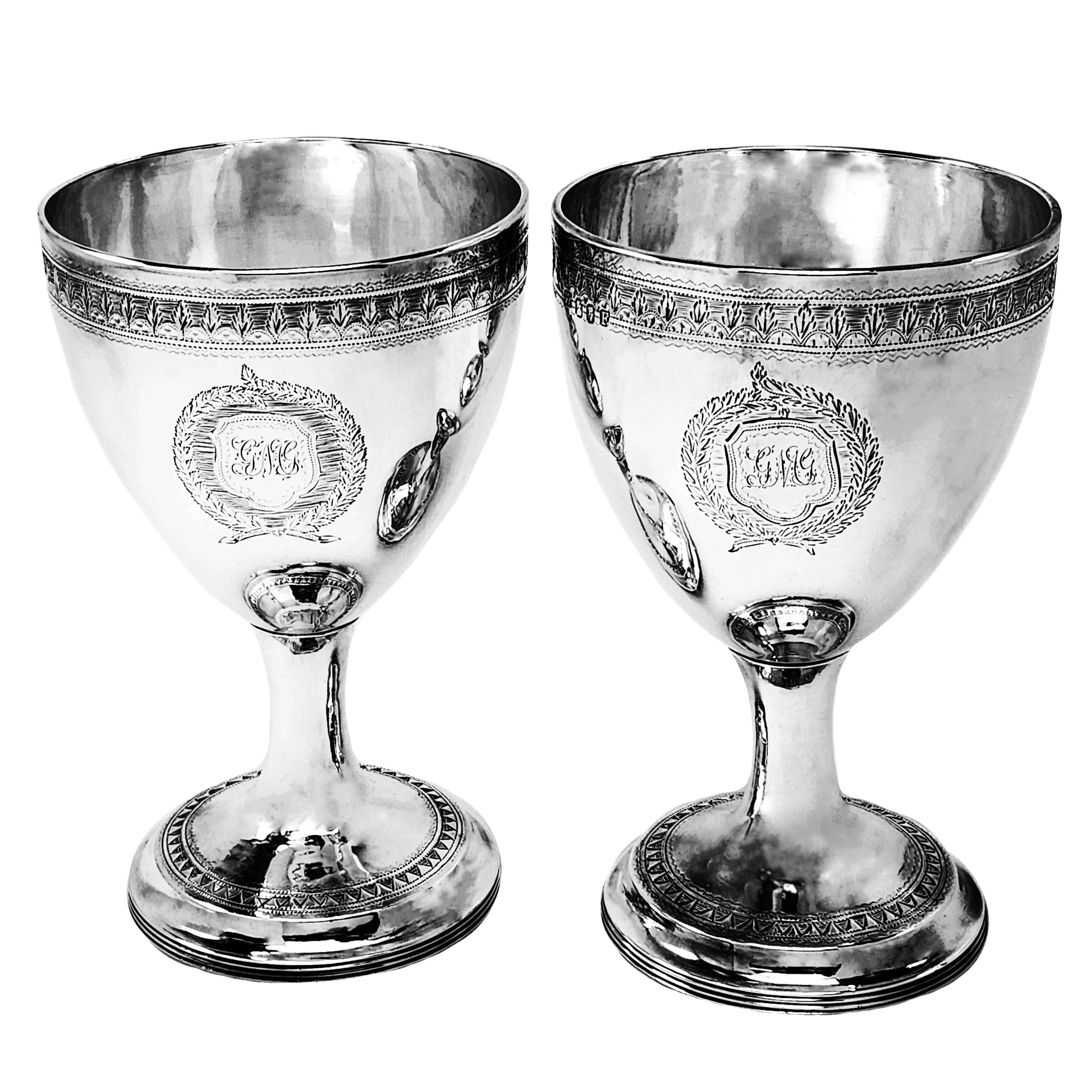 A pair of Antique Irish George III Silver Wine Goblets. These Goblets are of excellent size and each is embellished with bands of engraved patterns and each has two engraved crests.

Made in Dublin in 1802 & 1808 by Gustavas Byrne

Approx. Weight –