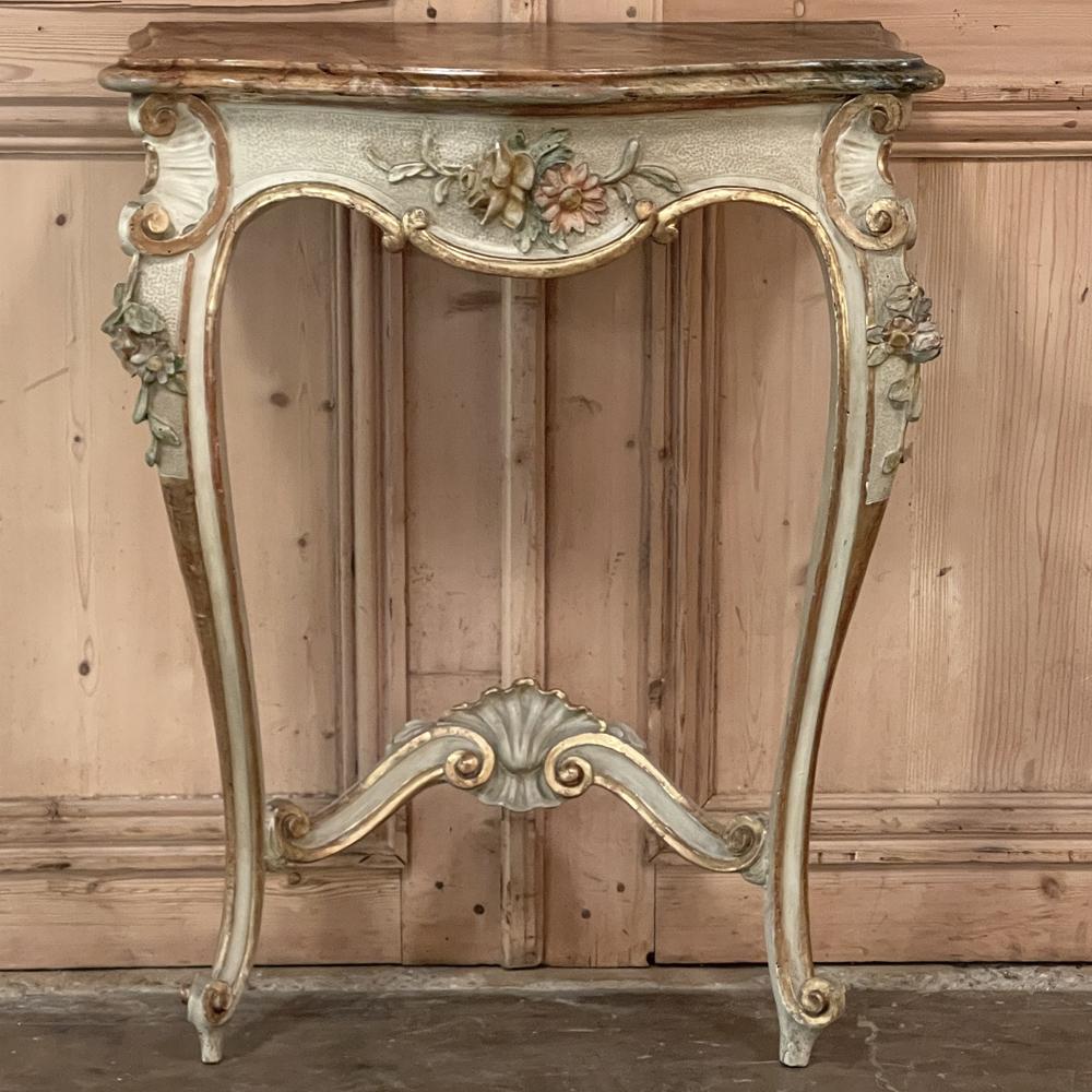 Pair Antique Italian hand-painted Consoles were sculpted in the Rococo style, and feature graceful cabriole legs connected with arched stretchers, all of which are carved with shell and floral designs. The contoured apron features a relief carving