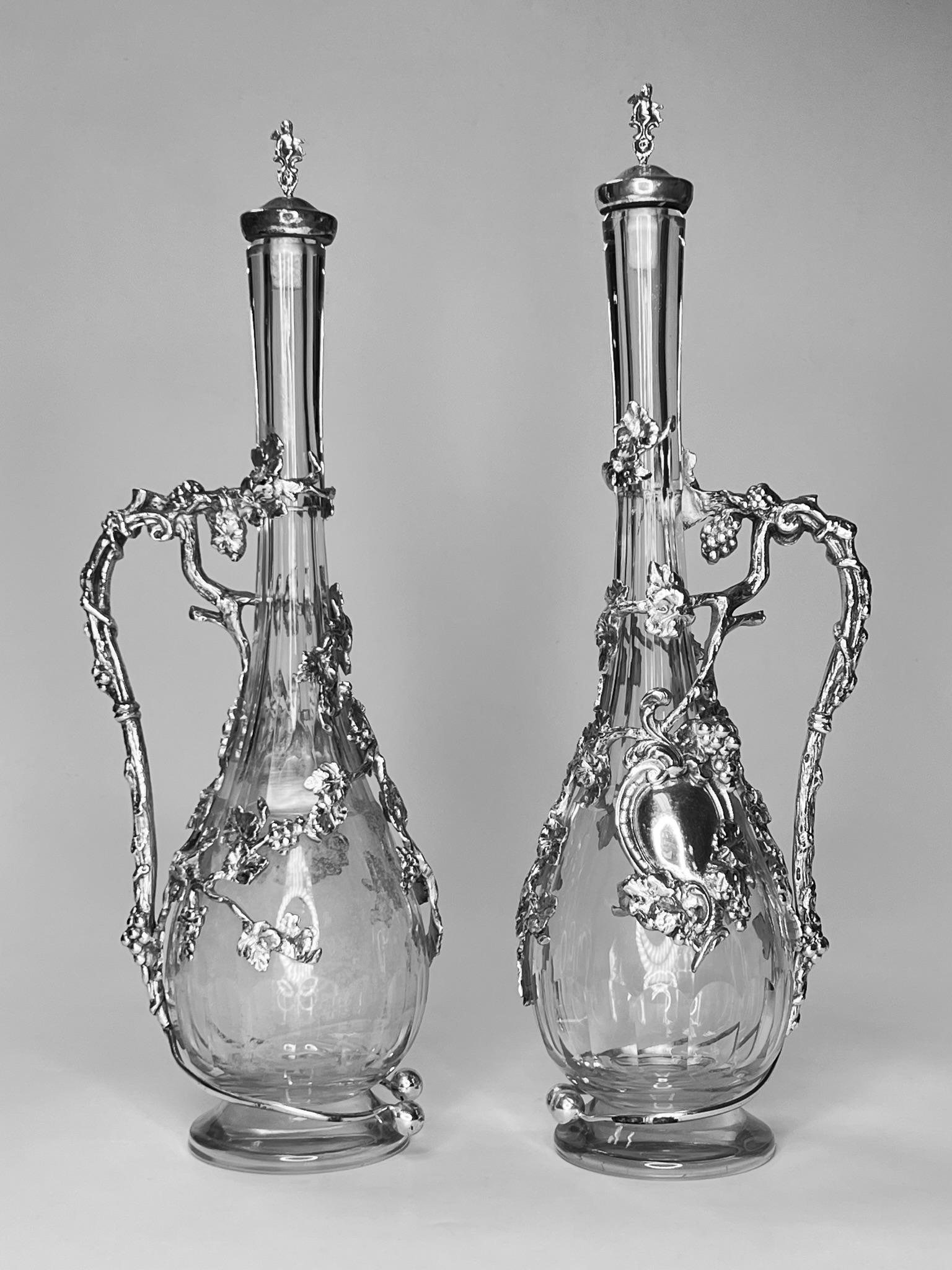 Pair of vintage Italian wine jugs by Peruzzi of Florence, Italy, with silver plate cork stoppers with figural finials with silver plate handles and frames with berry vine motif. Each stamped FIRENZE and PERUZZI.