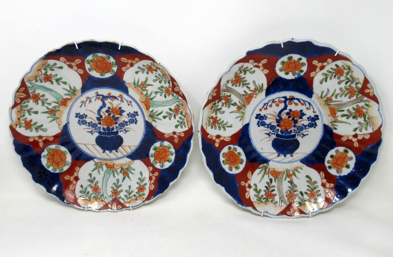 Stunning identical pair large Japanese or Chinese circular form Imari deep cabinet plates or centerpieces with ribbed surfaces and wavy rims, of outstanding quality, made during the last quarter of the 19th century.

Hand decorated with all-over