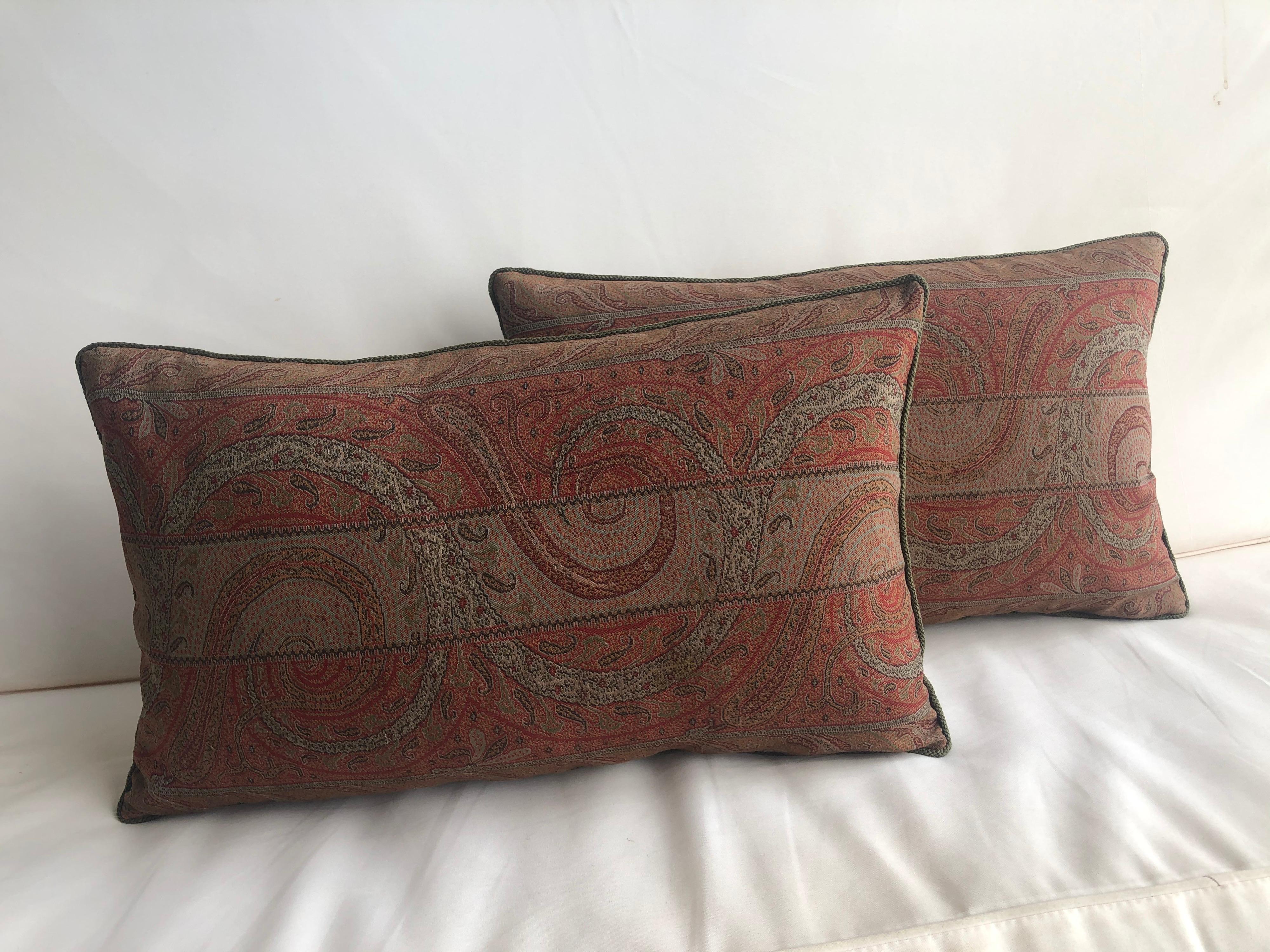 Antique wool paisley bolster pillow, embellished with small green rope trim all around and textured brown backing.
In shades of green, red, brown, orange, brown, black and yellow.
Needle embroidery. handcrafted decorative pillow made with a
