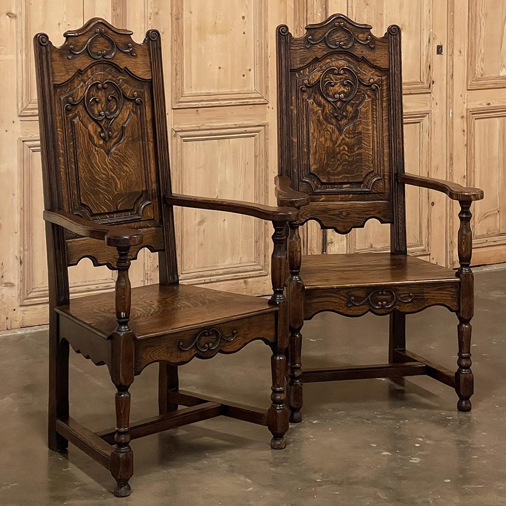 Pair antique Liegoise Louis XIV solid oak armchairs are perfect for creating a stately presence in any seating group! Hand-crafted from quarter-sawn oak, each features an arched seatback crown with foliate embellishment appearing over the finely