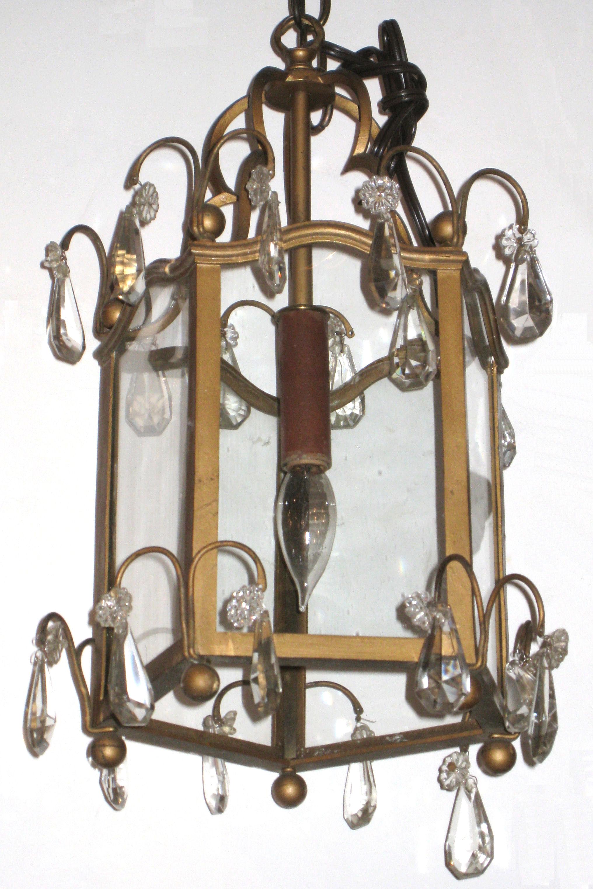 Pair of antique (late 19th century) metal lanterns with hexogonal form with ball finials and crystal glass pendants in the English Georgian / French Louis XVI style.  With one electrified sockets and hardwired.
