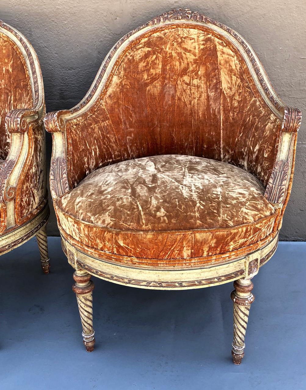 This is an outstanding pair of late 19th or early 20th century Italian or French Painted Louis XVI -style bergeres. The bergeres were beautifully crafted; the carved Louis XVI frames retain their original painted surface in ivory with highlights in